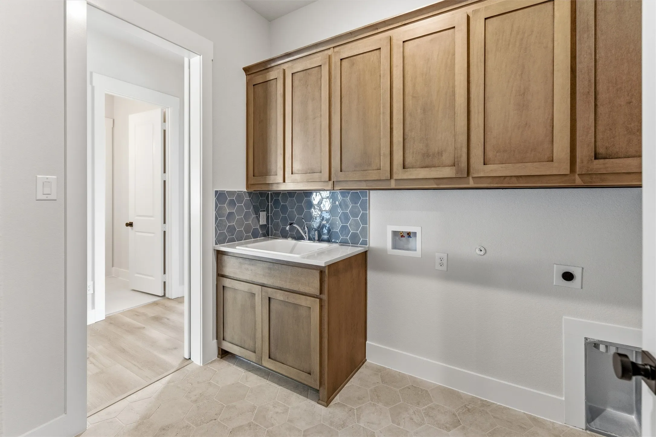 Laundry room featuring hookup for a washing machine, hookup for an electric dryer, and cabinet space