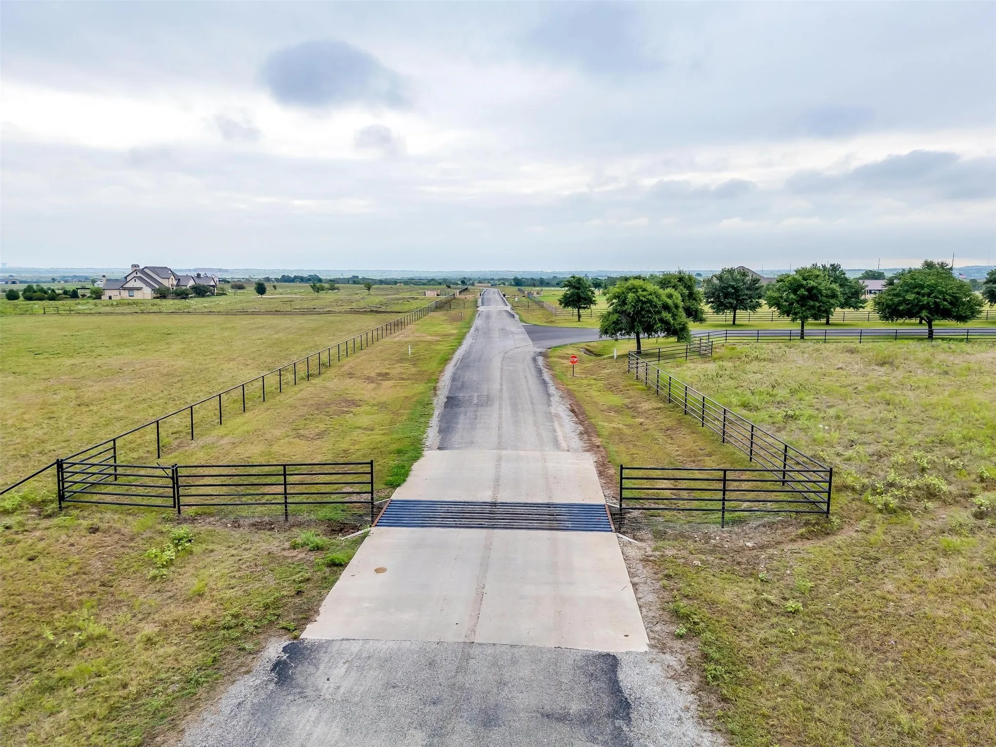 The property it to the Right of the cattle guard, this is the main road