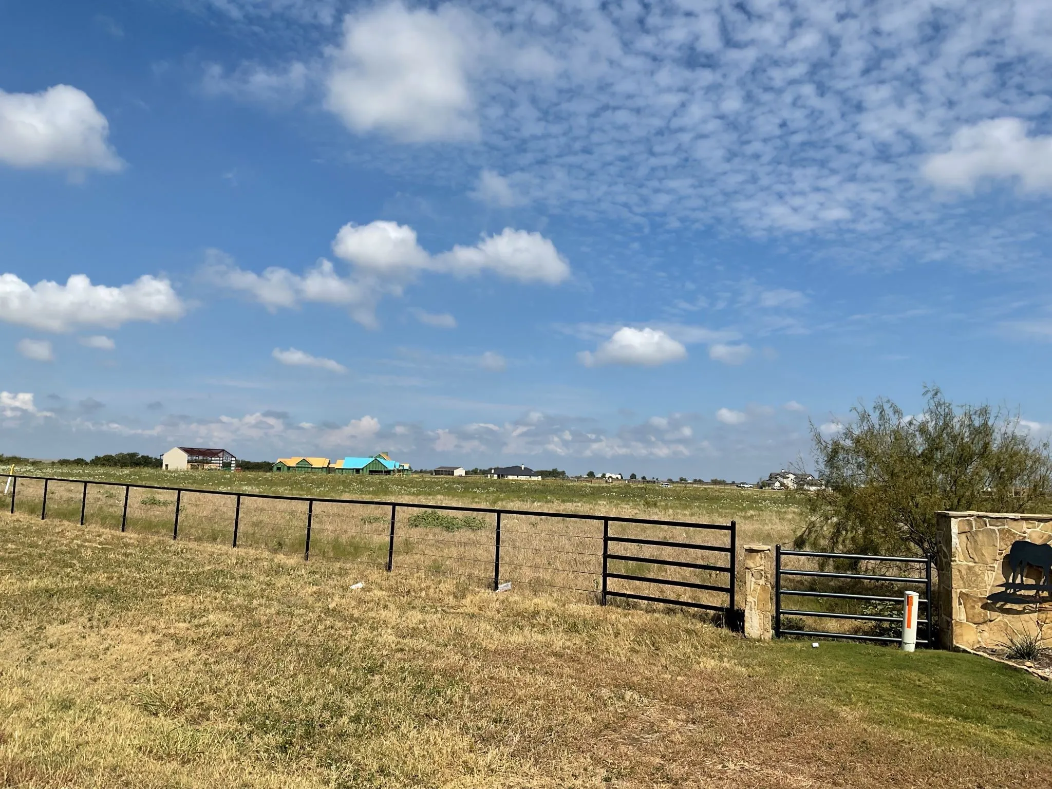 View from the Highway 1187 side.  The property fronts Hwy 1187 and has pipe fencing along that side of the property
