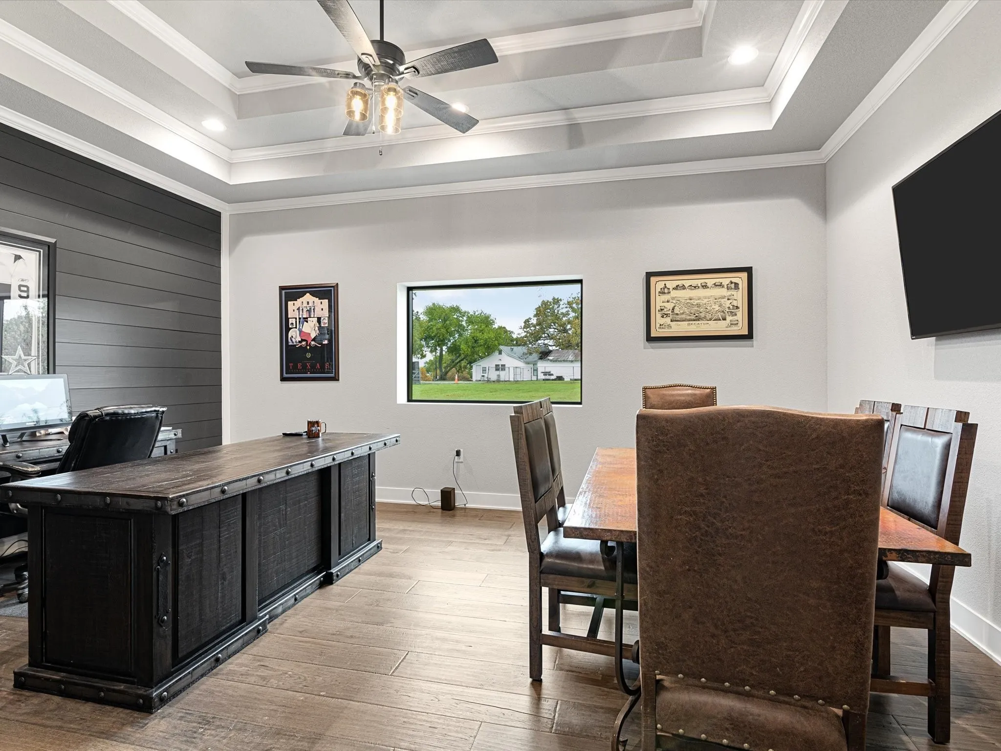Office space featuring crown molding, hardwood / wood-style floors, ceiling fan, recessed lighting, and wooden walls