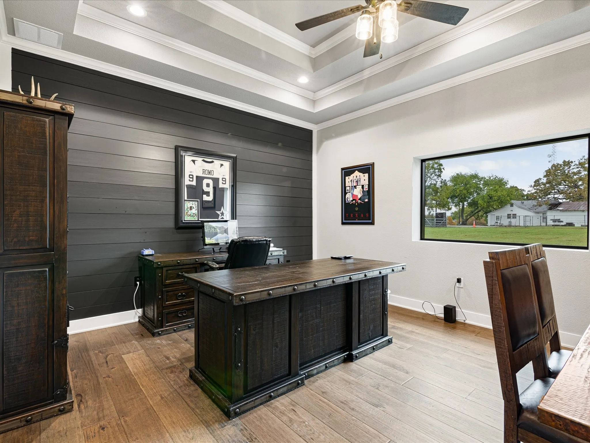 Office space with a tray ceiling, hardwood / wood-style floors, a ceiling fan, crown molding, and recessed lighting