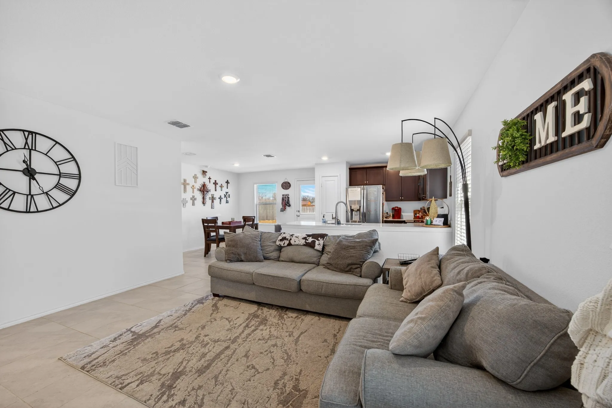 Living area with recessed lighting and light tile patterned floors