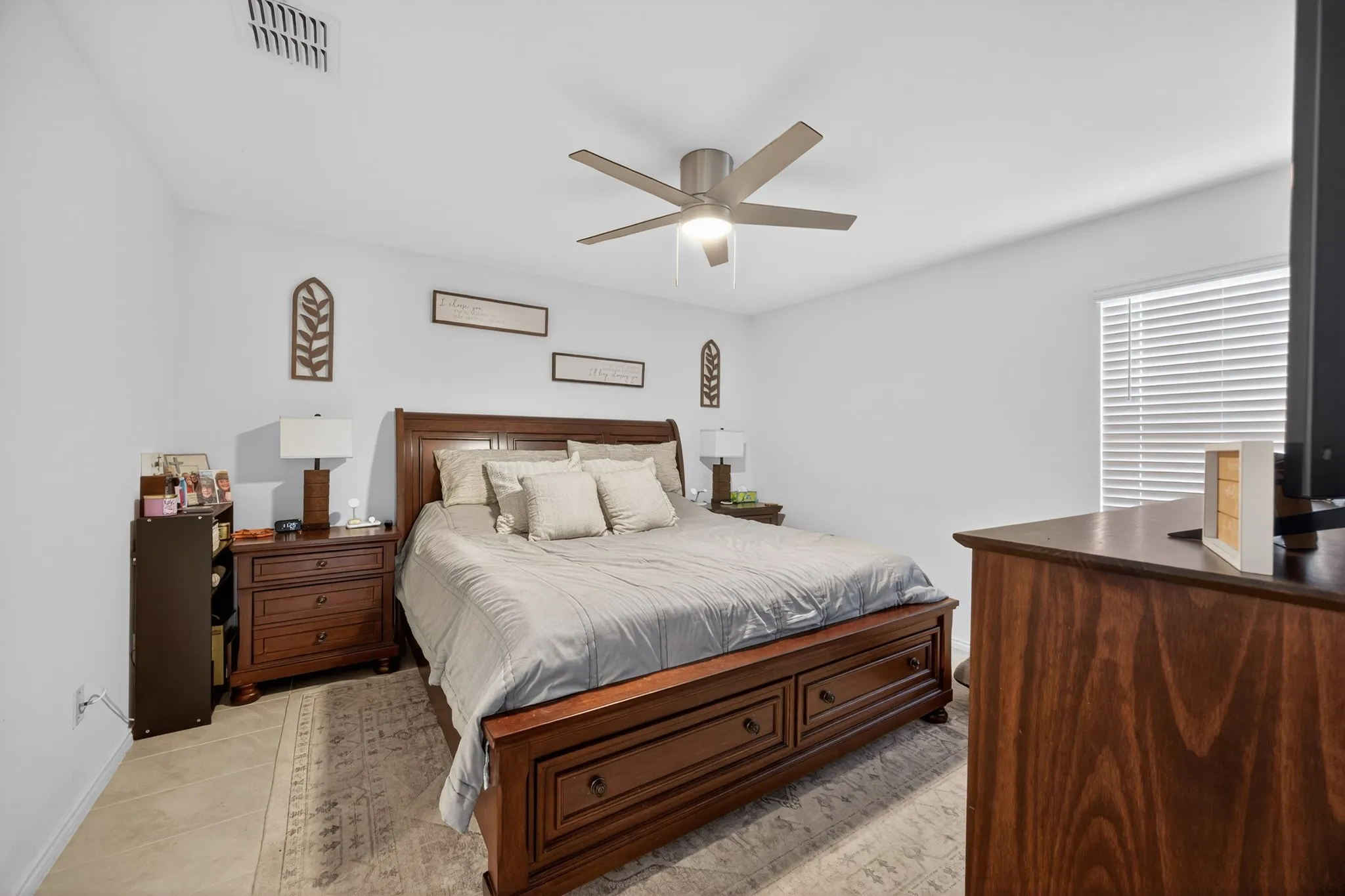 Bedroom with ceiling fan and light tile patterned floors