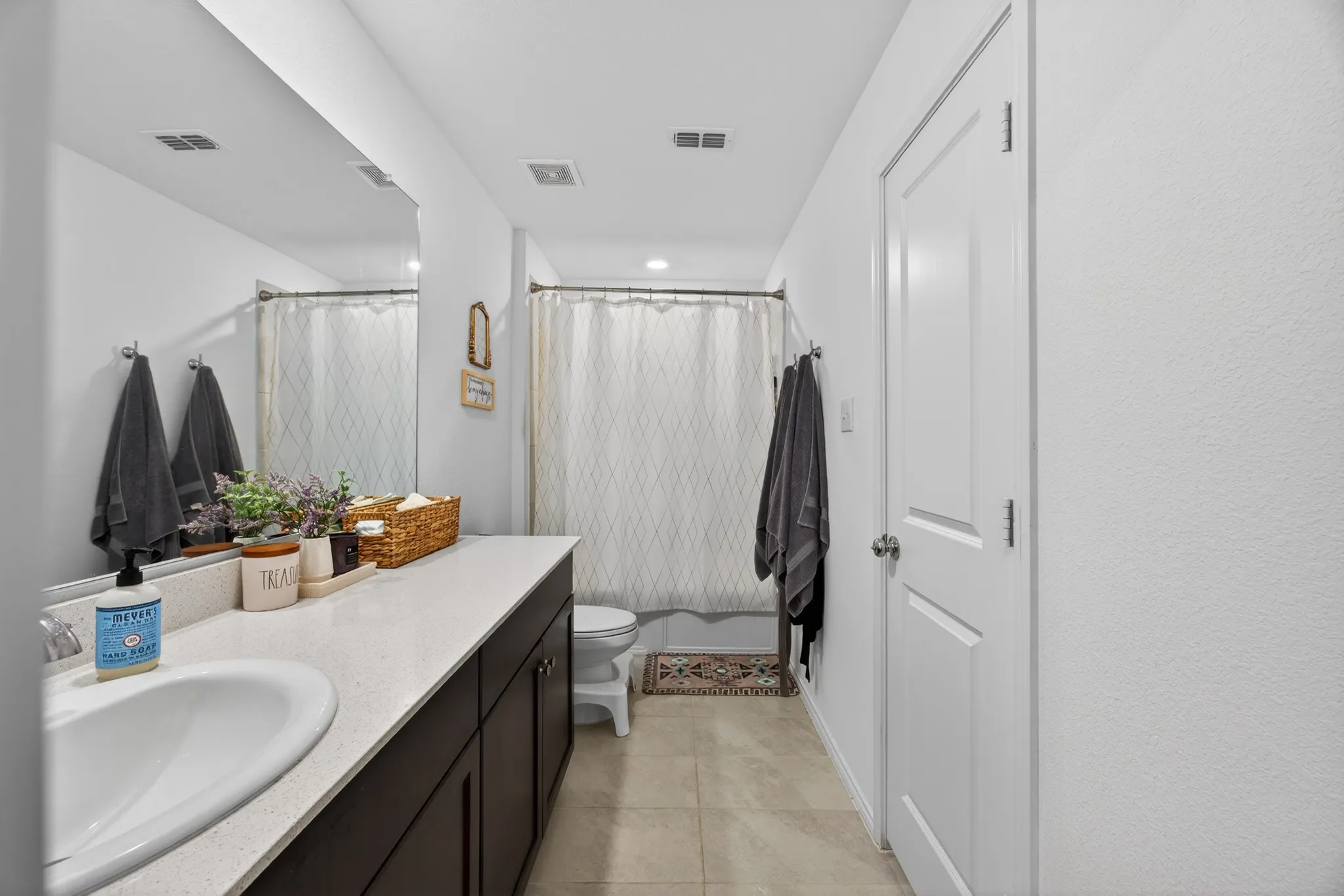 Bathroom with vanity and light tile patterned floors