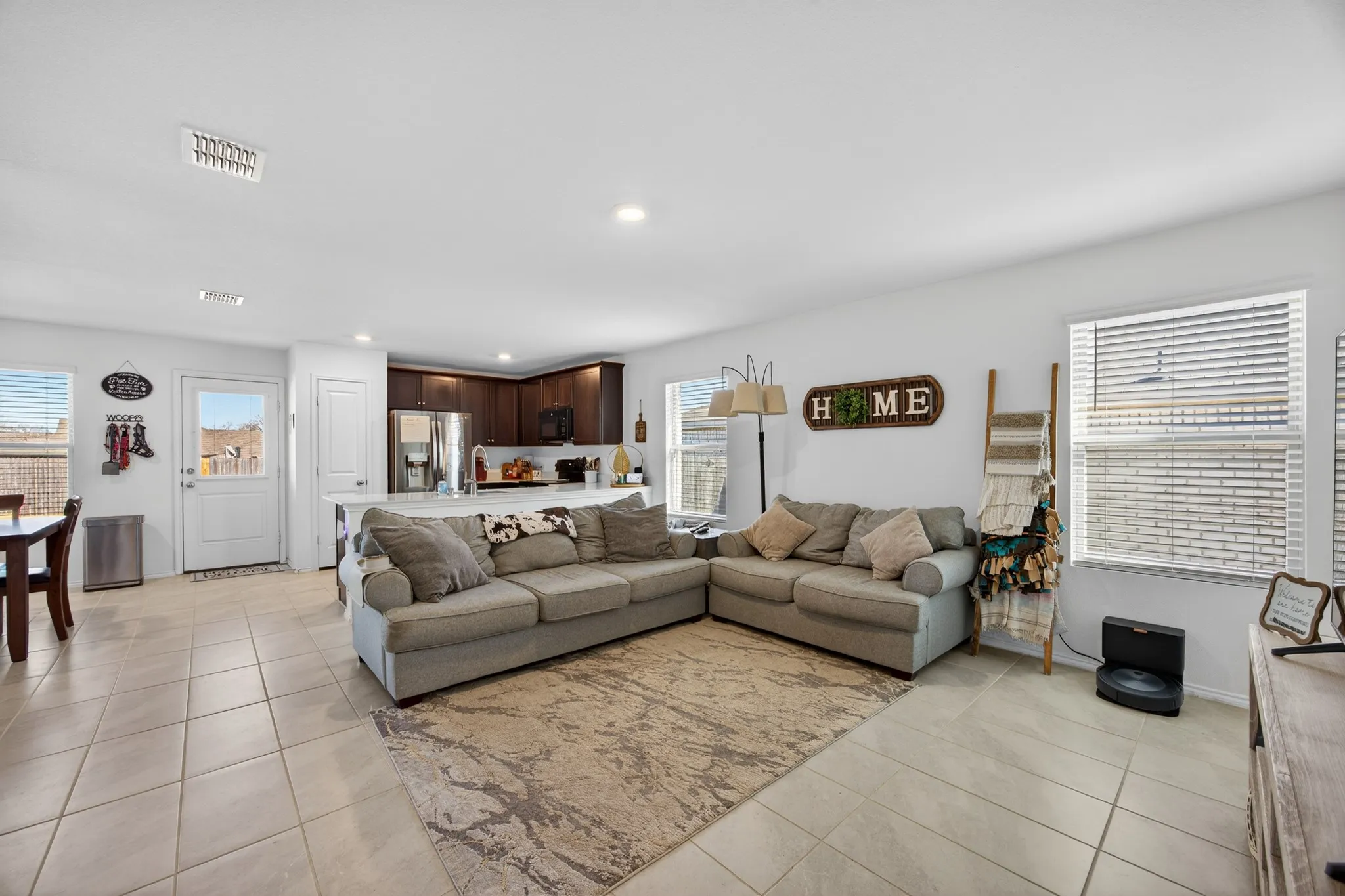 Living area with plenty of natural light, light tile patterned floors, and recessed lighting