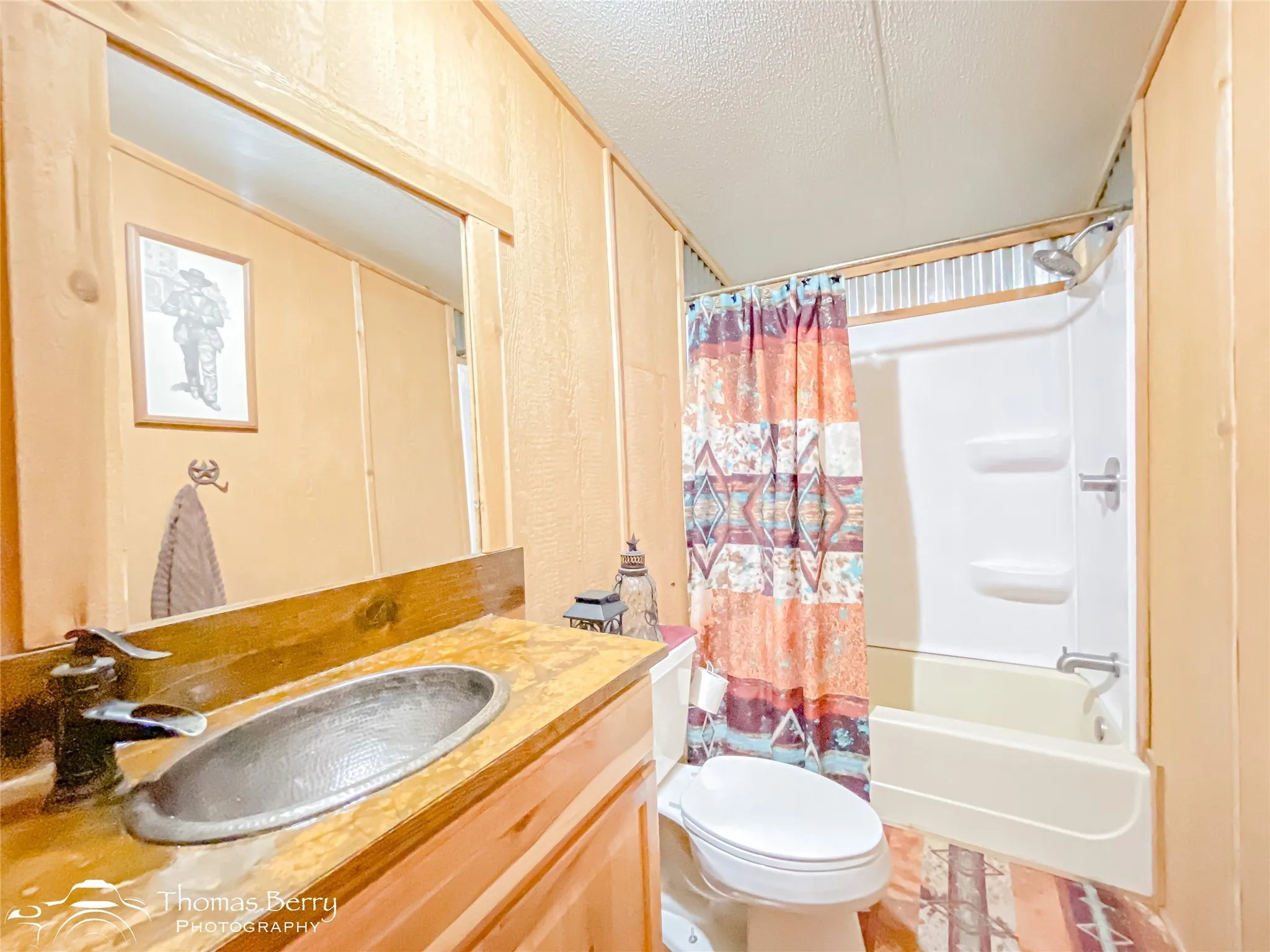 Full bath with shower / bathtub combination with curtain, vanity, and a textured ceiling