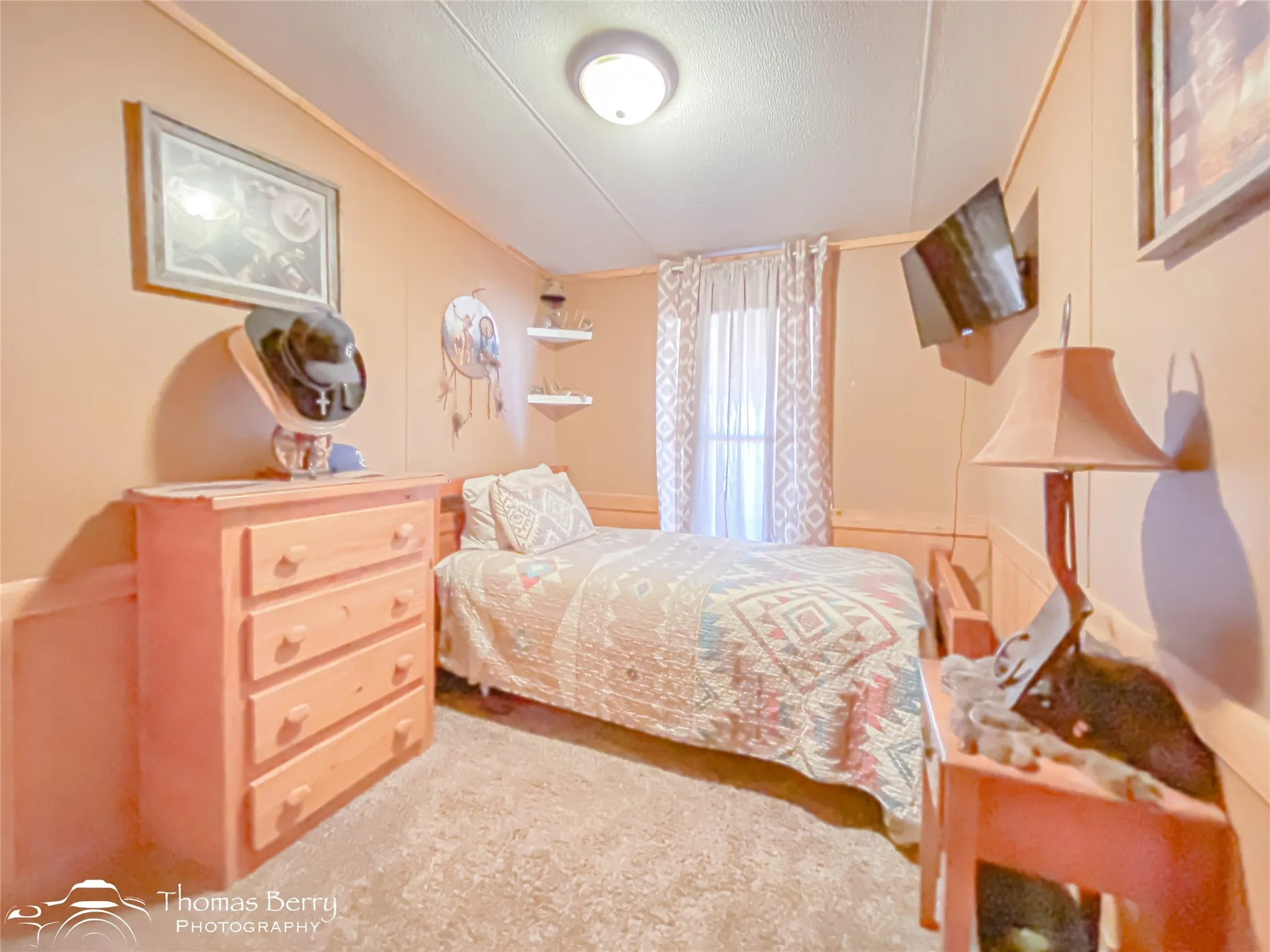 Bedroom featuring a textured ceiling and carpet
