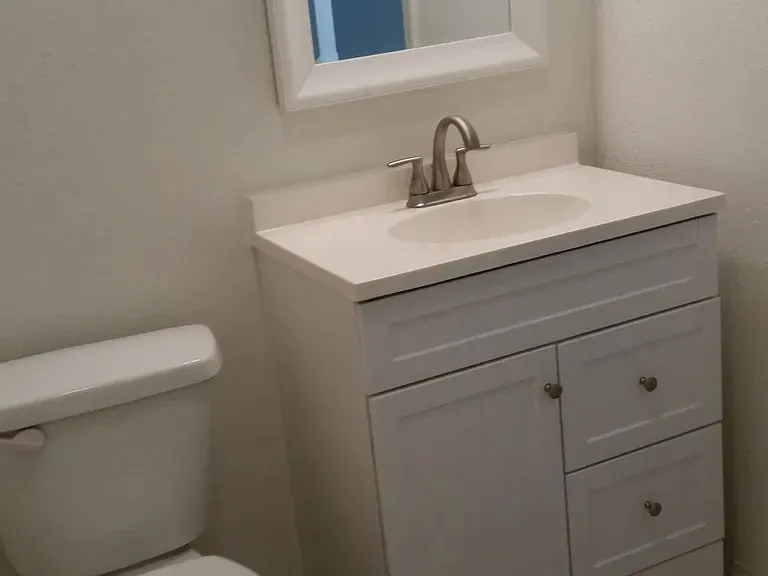Half bathroom featuring vanity and toilet