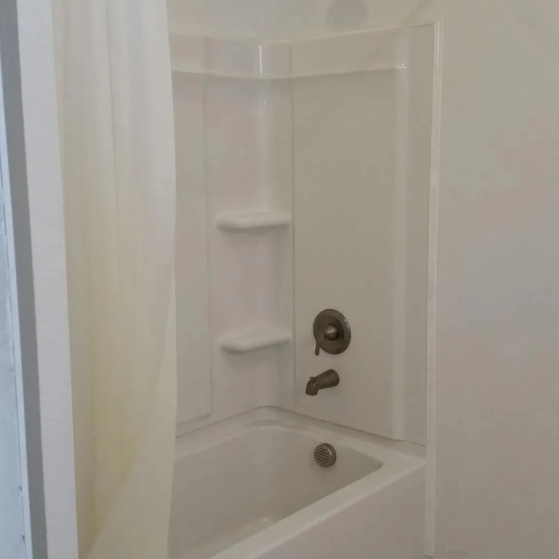 Full bathroom featuring shower / bathtub combination with curtain
