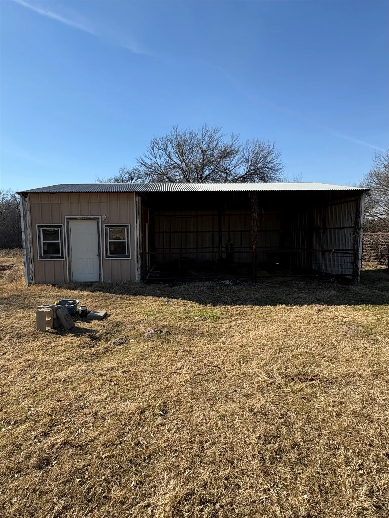 Pole barn equipped with water and electricity. Nice tool or tack room.  Would make a perfect spot for 4-H or FFA livestock projects.