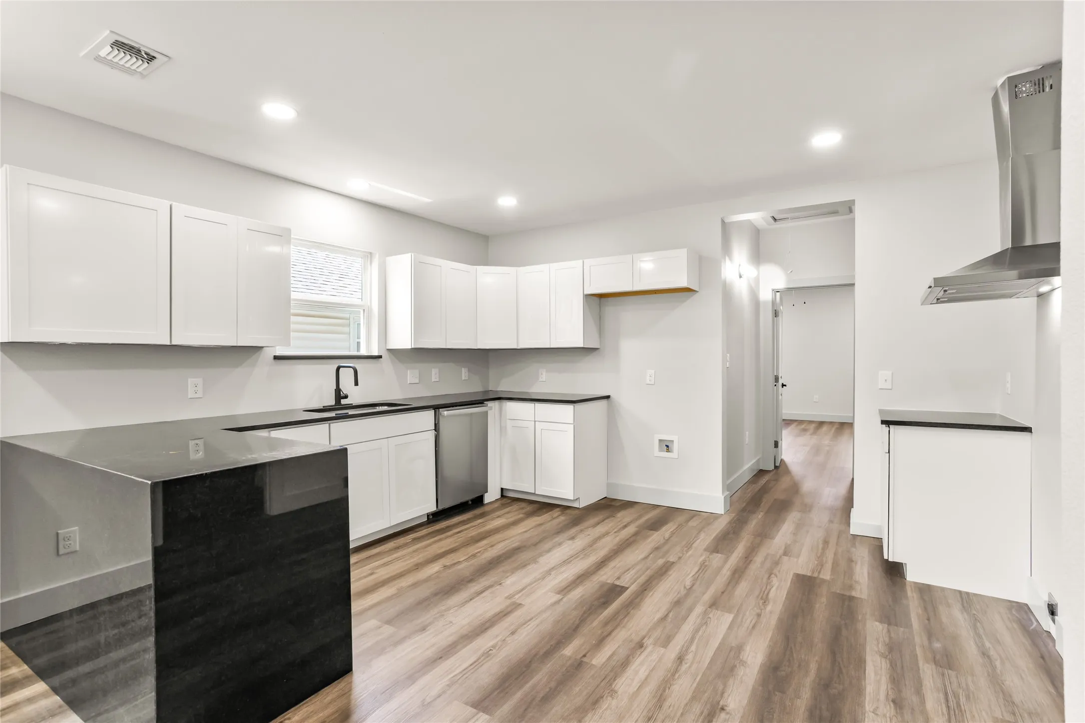 Modern kitchen with granite countertops, clean cabinetry, and functional flow.
