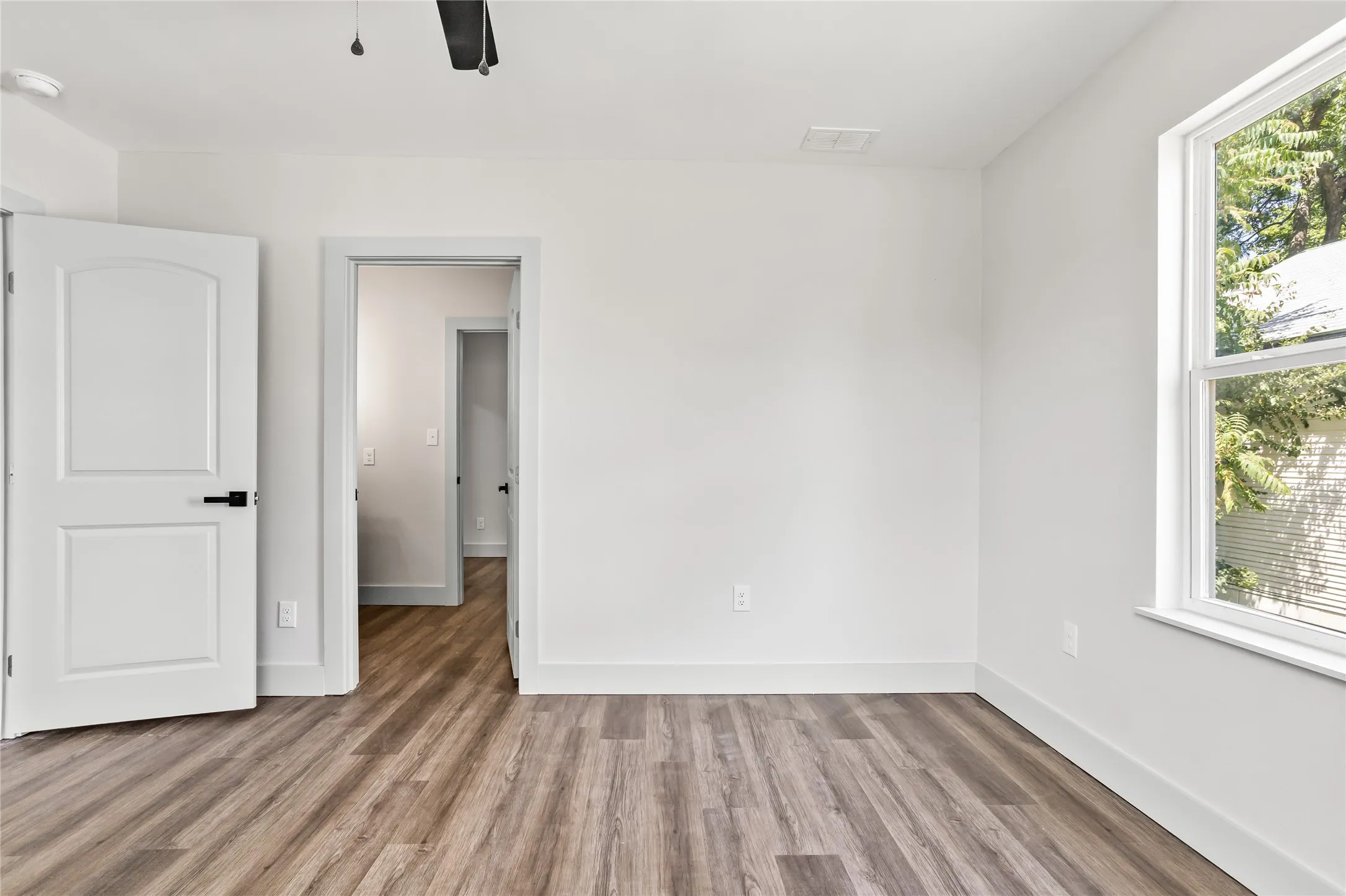 This shows the view from the front secondary bedroom through the Jack and Jill bathroom and into the back secondary bedroom.