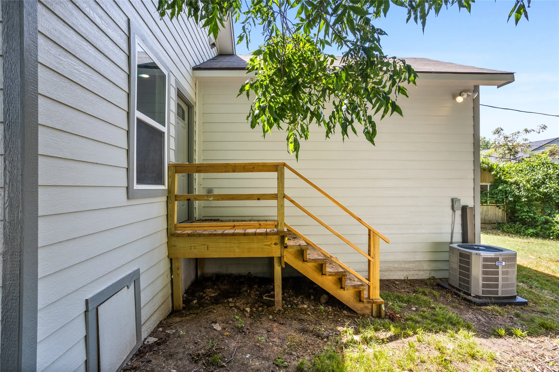 Stepping out of the back door, you will be a on a new back porch.  You will also see the new condenser here.