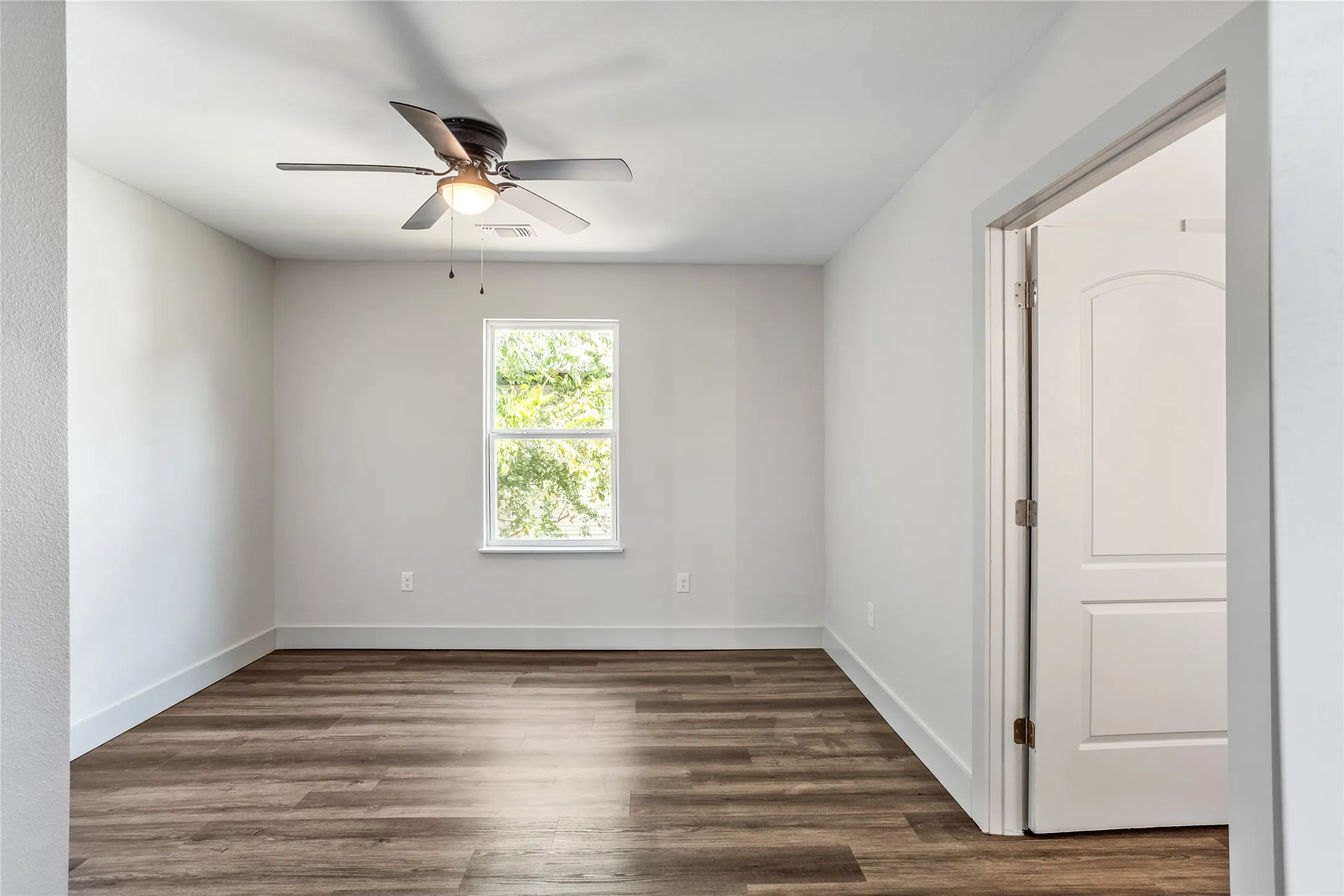 The back secondary bedroom is the second room off the living area.