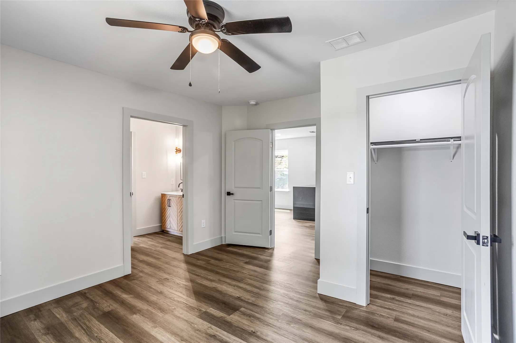 In the back secondary bedroom, you can see the Jack and Jill bathroom on the left, the corner of the kitchen cabinet, and the closet for this room.