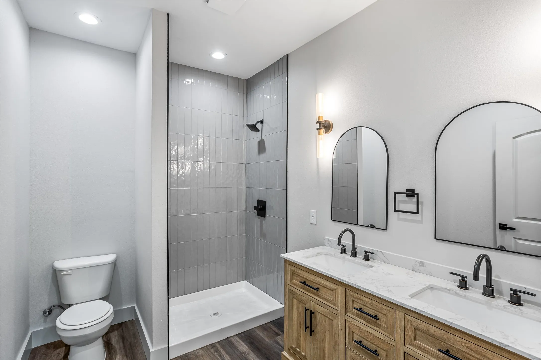 The primary bath has a very tall stand-up shower and double vanities.
