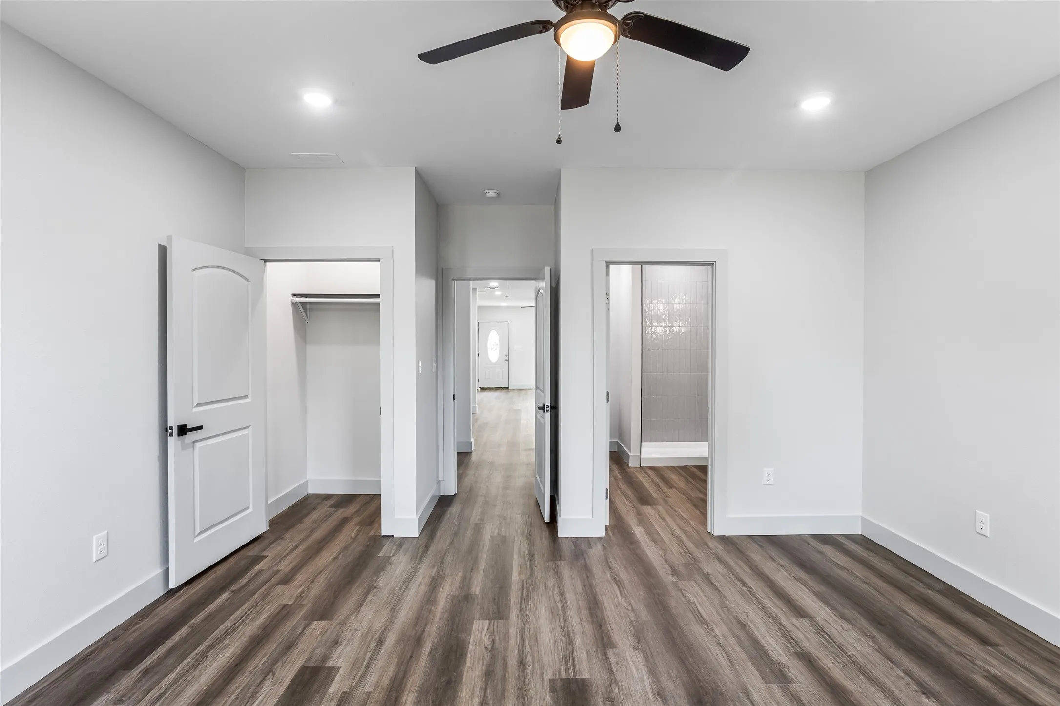 From the primary bedroom, you can see through the home to the front door,