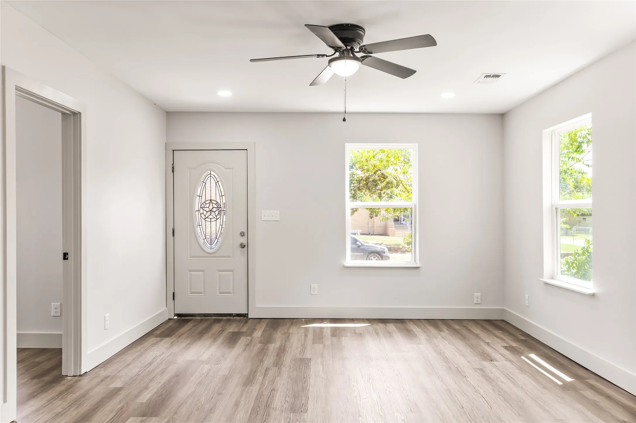 Enter through this door into a bright, light-filled living area that shines!