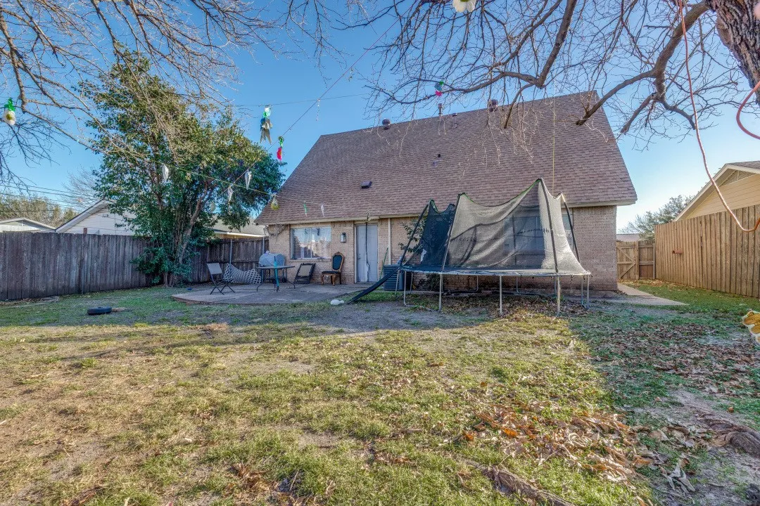 Backyard shaded by mature trees, fully fenced