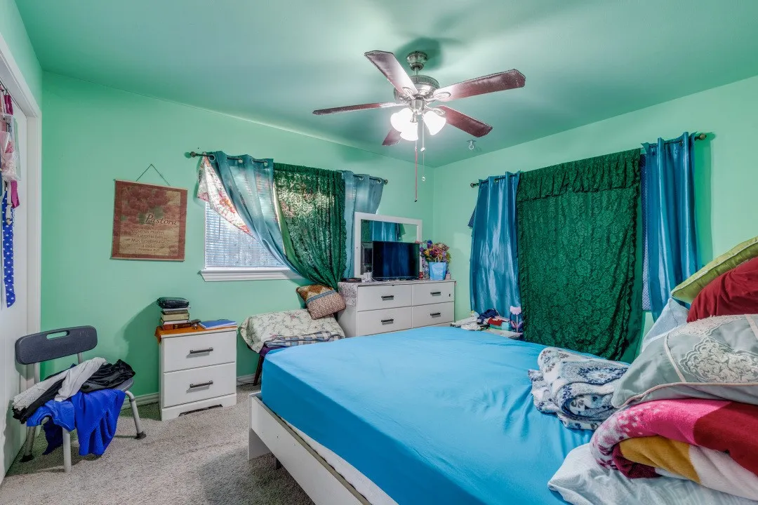 Comfortable bedroom with ceiling fan