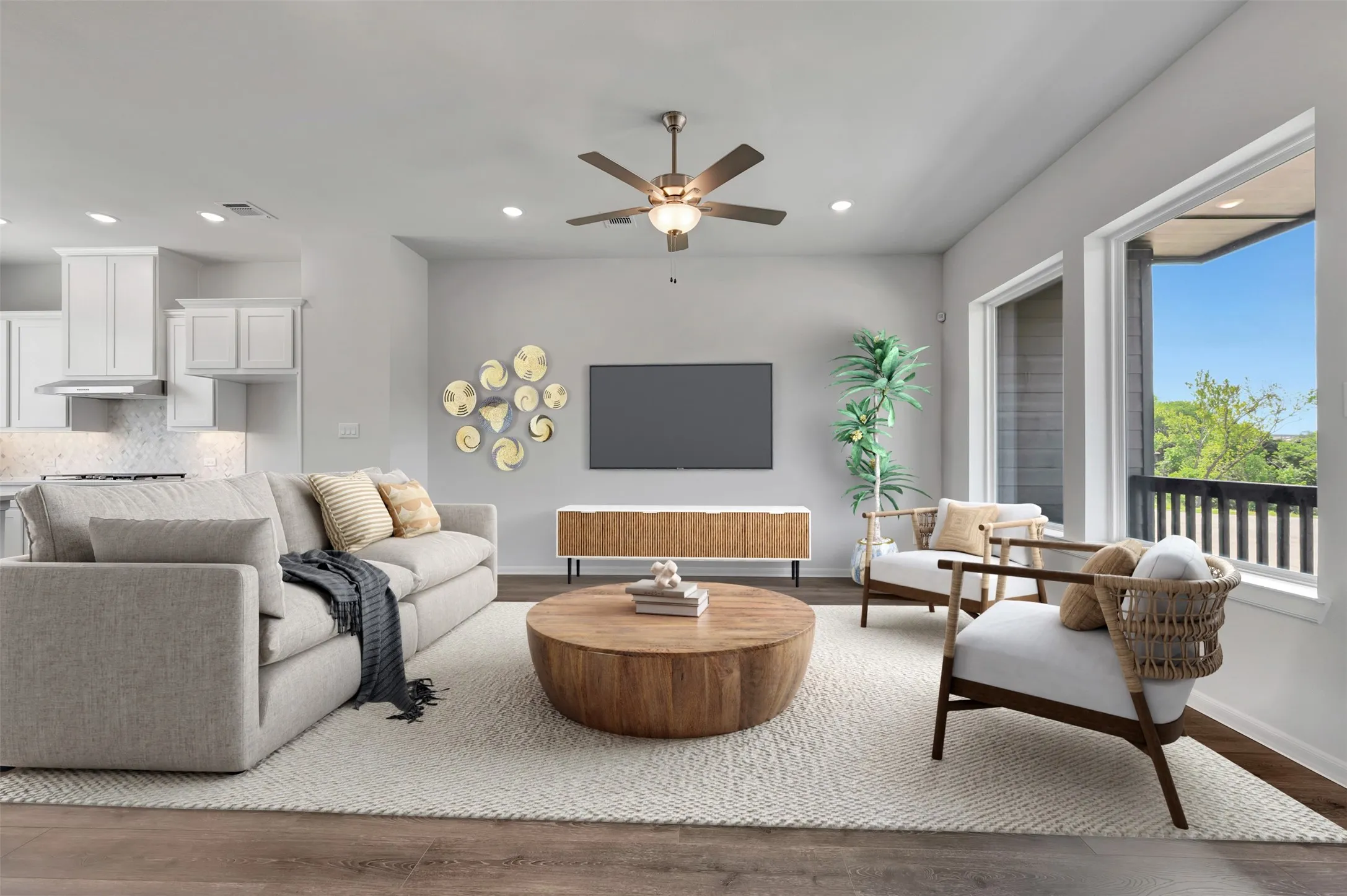 Open-concept living space featuring wood-finish flooring, recessed lighting, and a ceiling fan