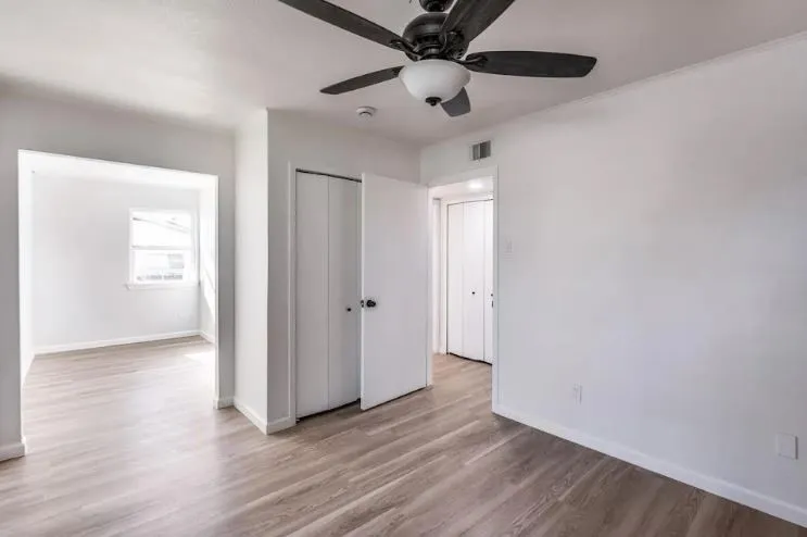 Bedroom with consistent flooring throughout the home