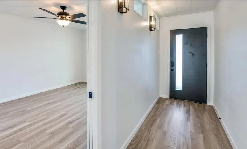 Front Door, foyer, and room with wood floors