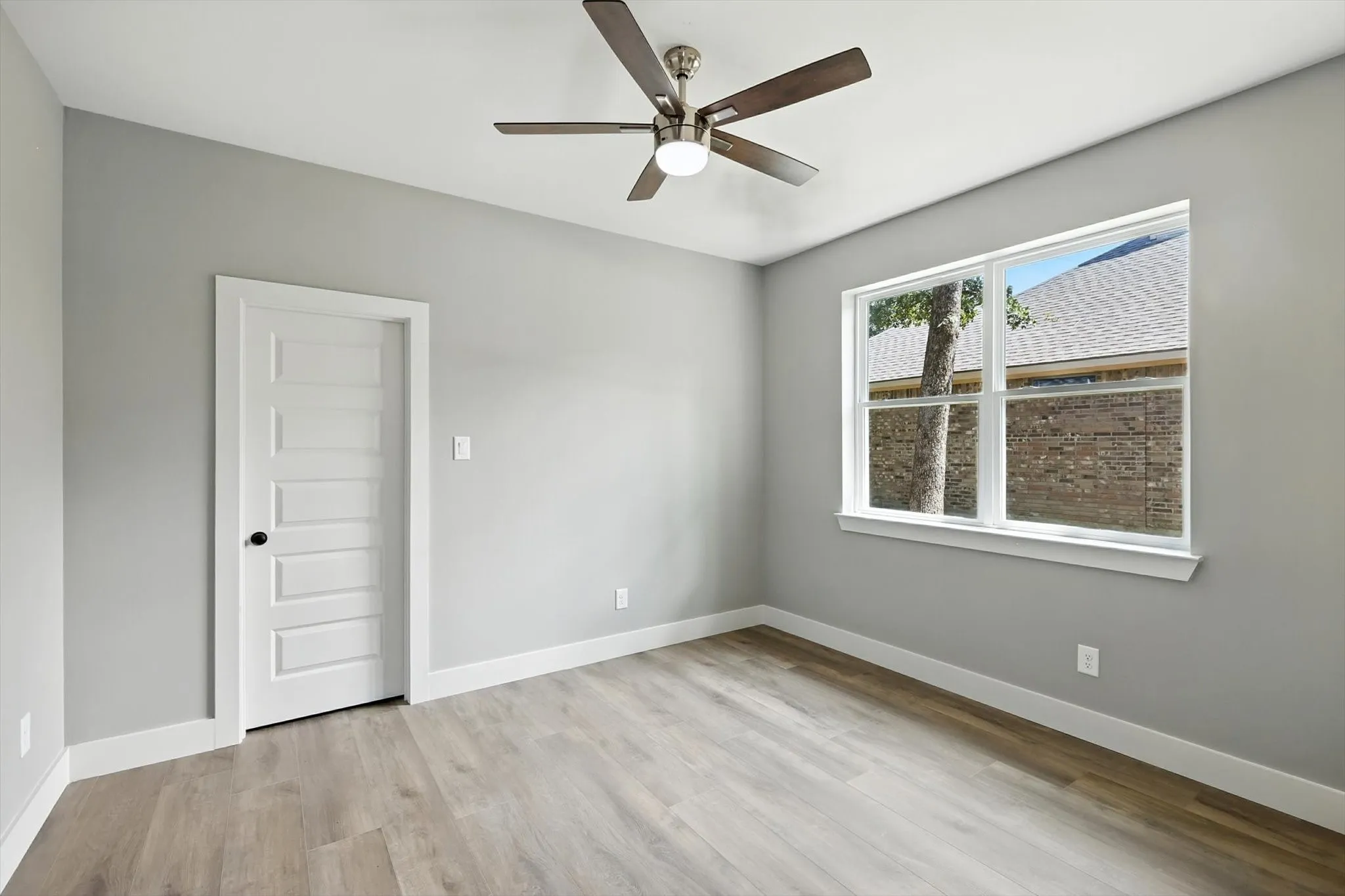 Spare room with light wood-style floors and a ceiling fan