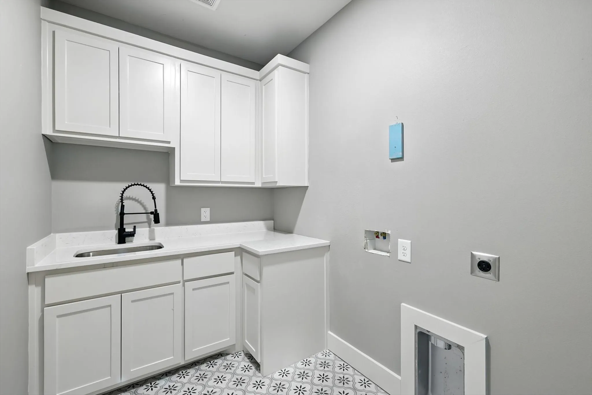 Laundry area featuring washer hookup, cabinet space, and electric dryer hookup