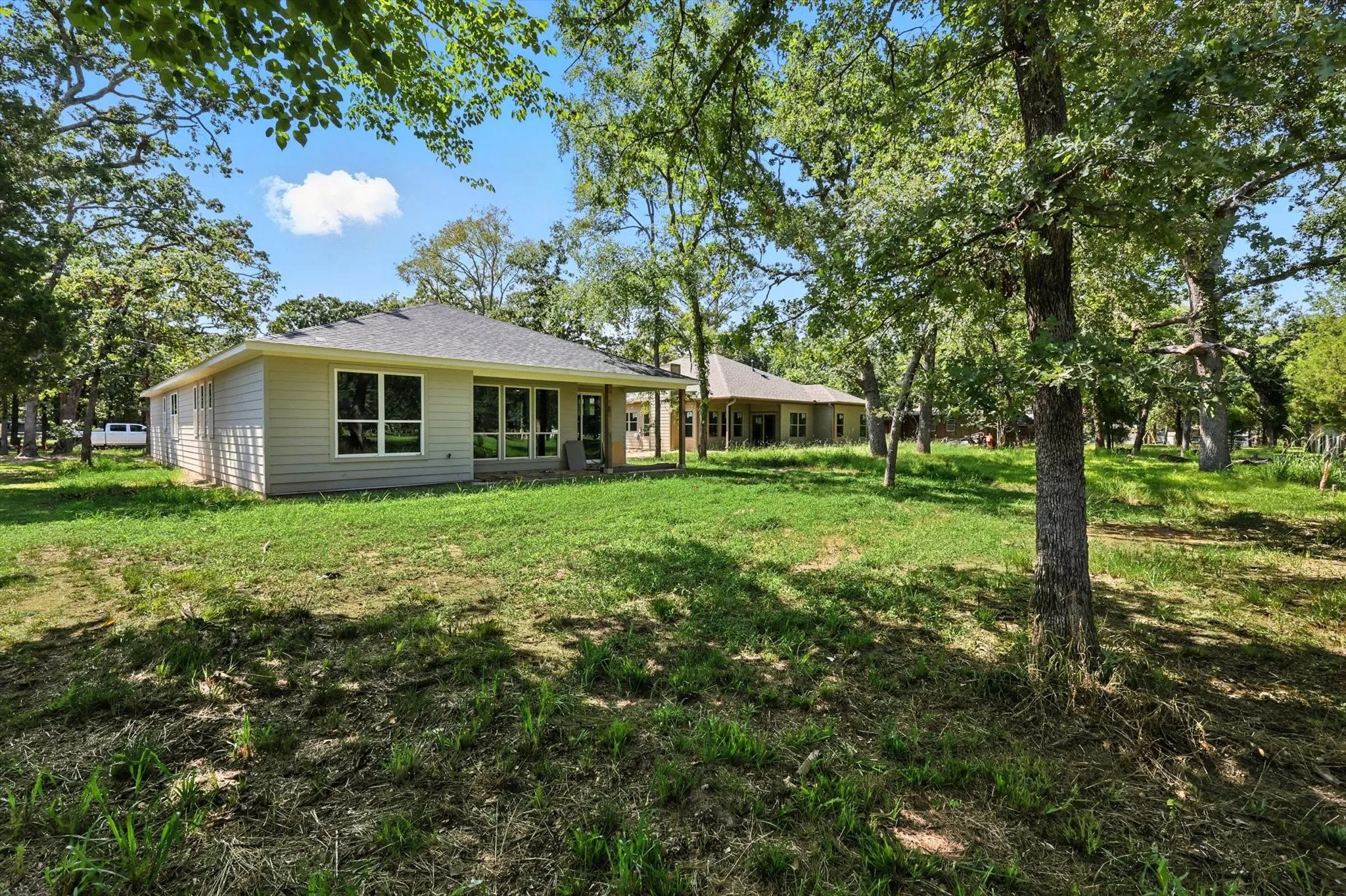 Back of house with a yard and a patio