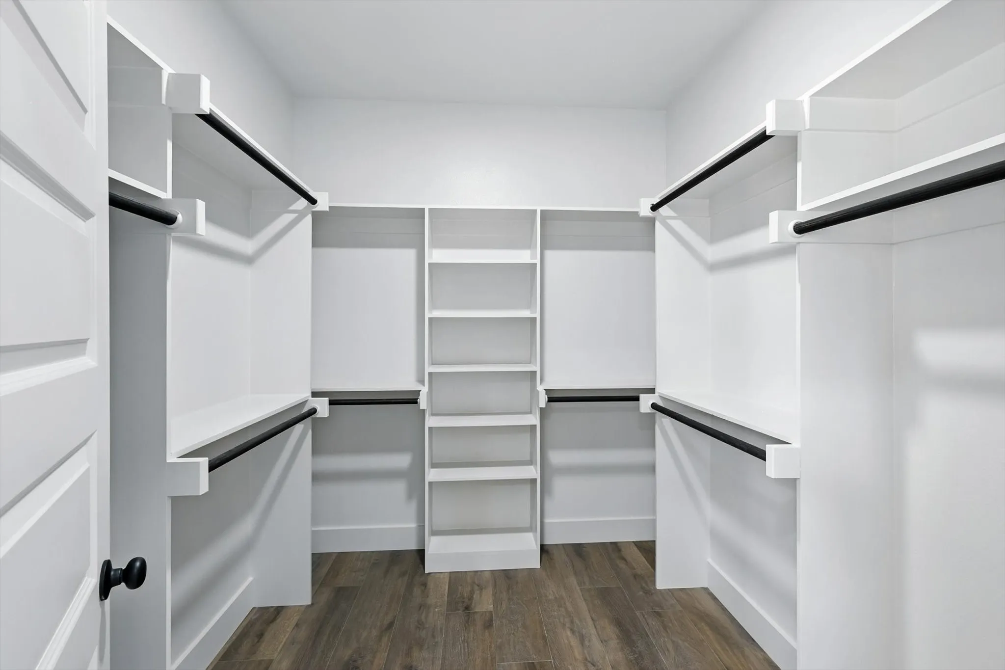 Walk in closet featuring dark wood-type flooring