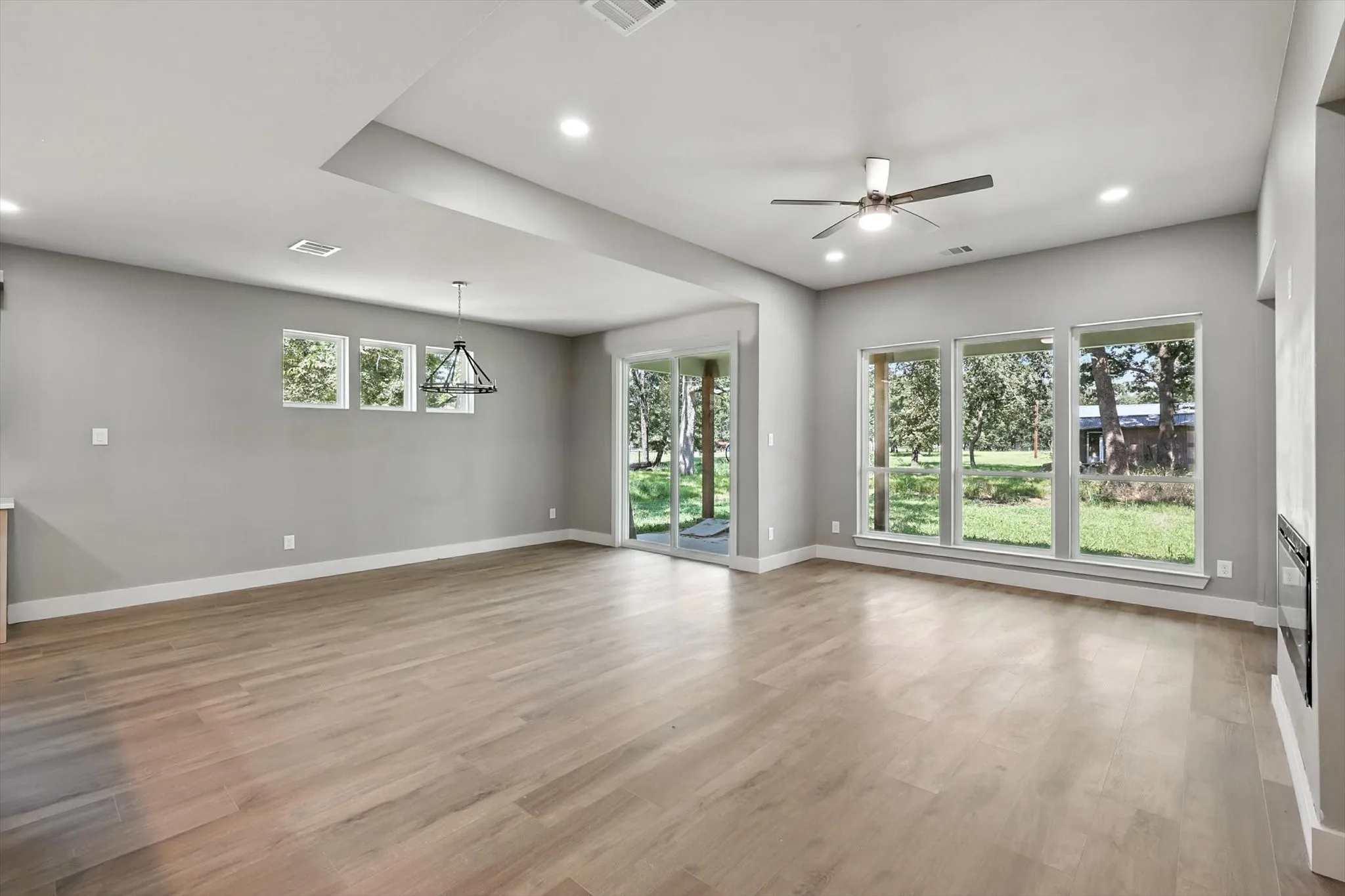 Unfurnished living room with light wood-style floors, recessed lighting, and ceiling fan