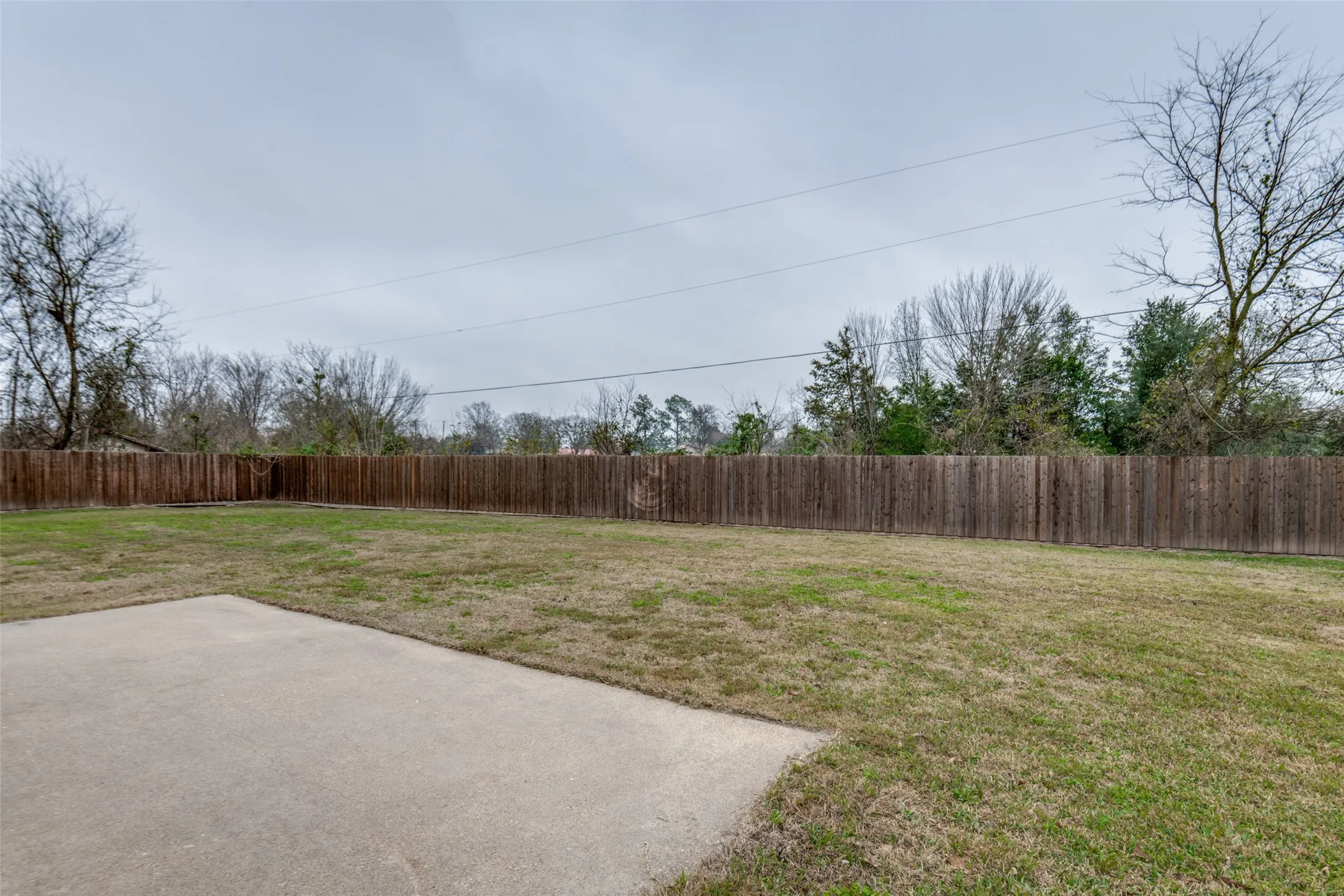 Fenced backyard with a patio