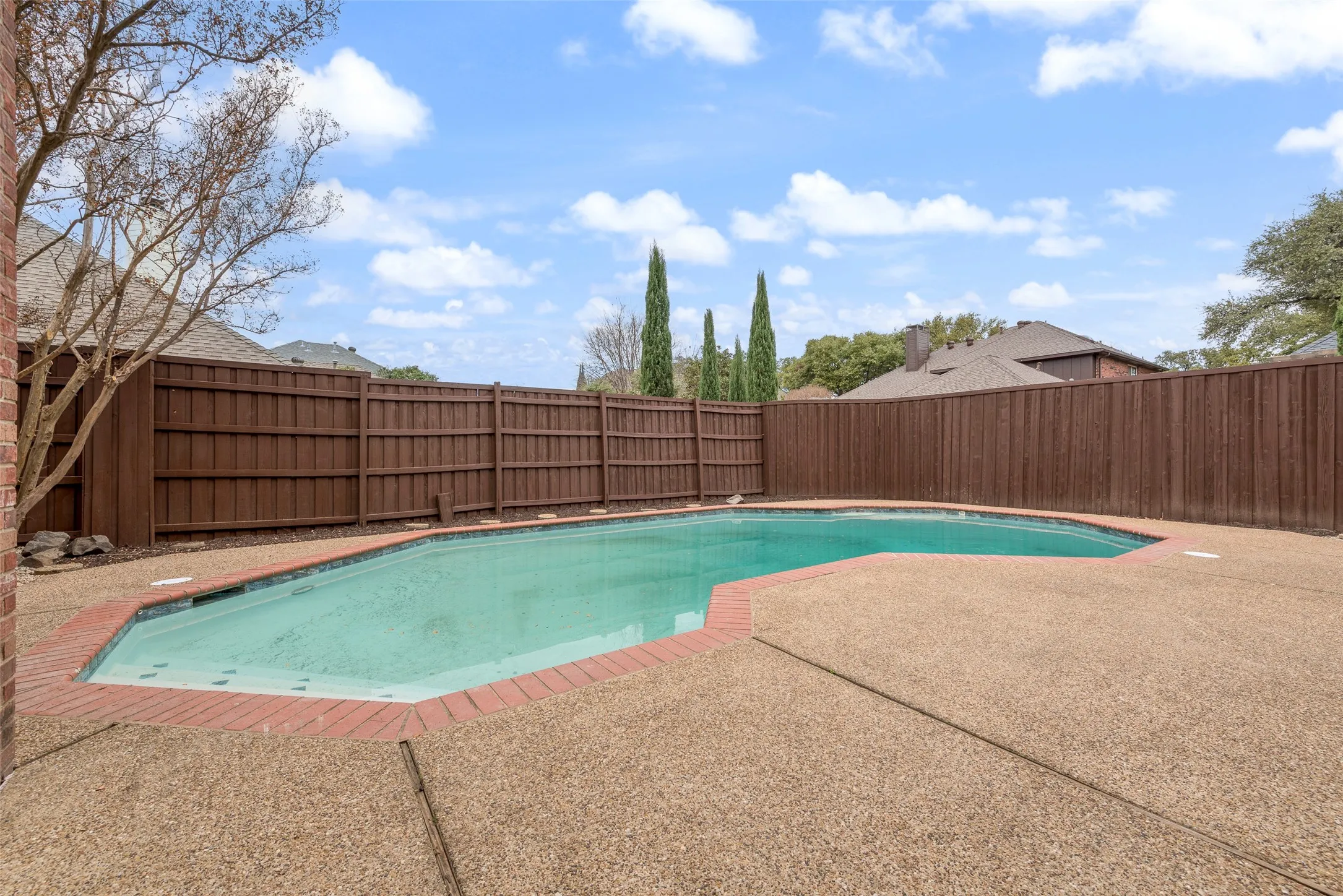 View of swimming pool featuring a fenced backyard and a patio area