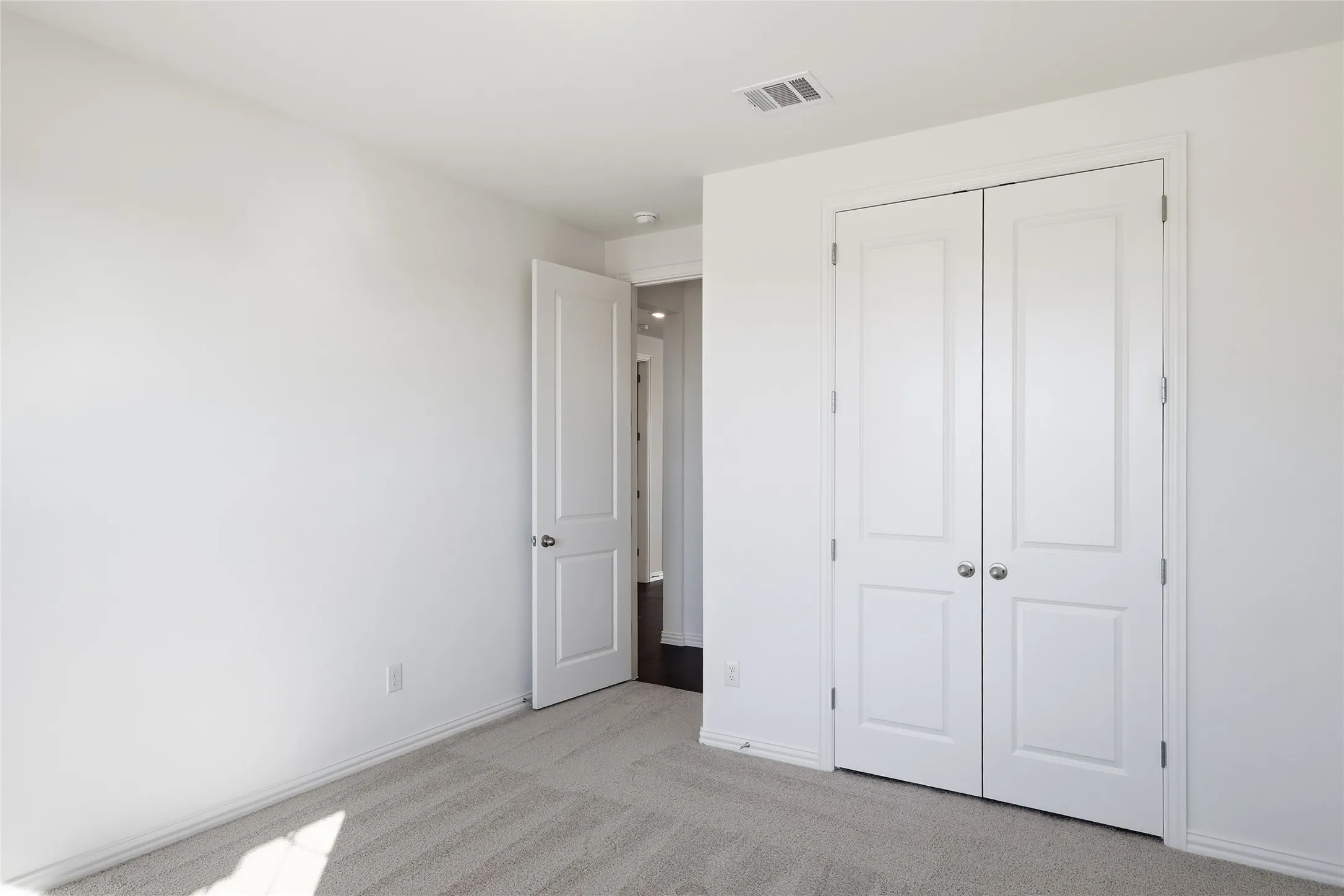 Neutral-toned carpet flooring complementing white walls and trim