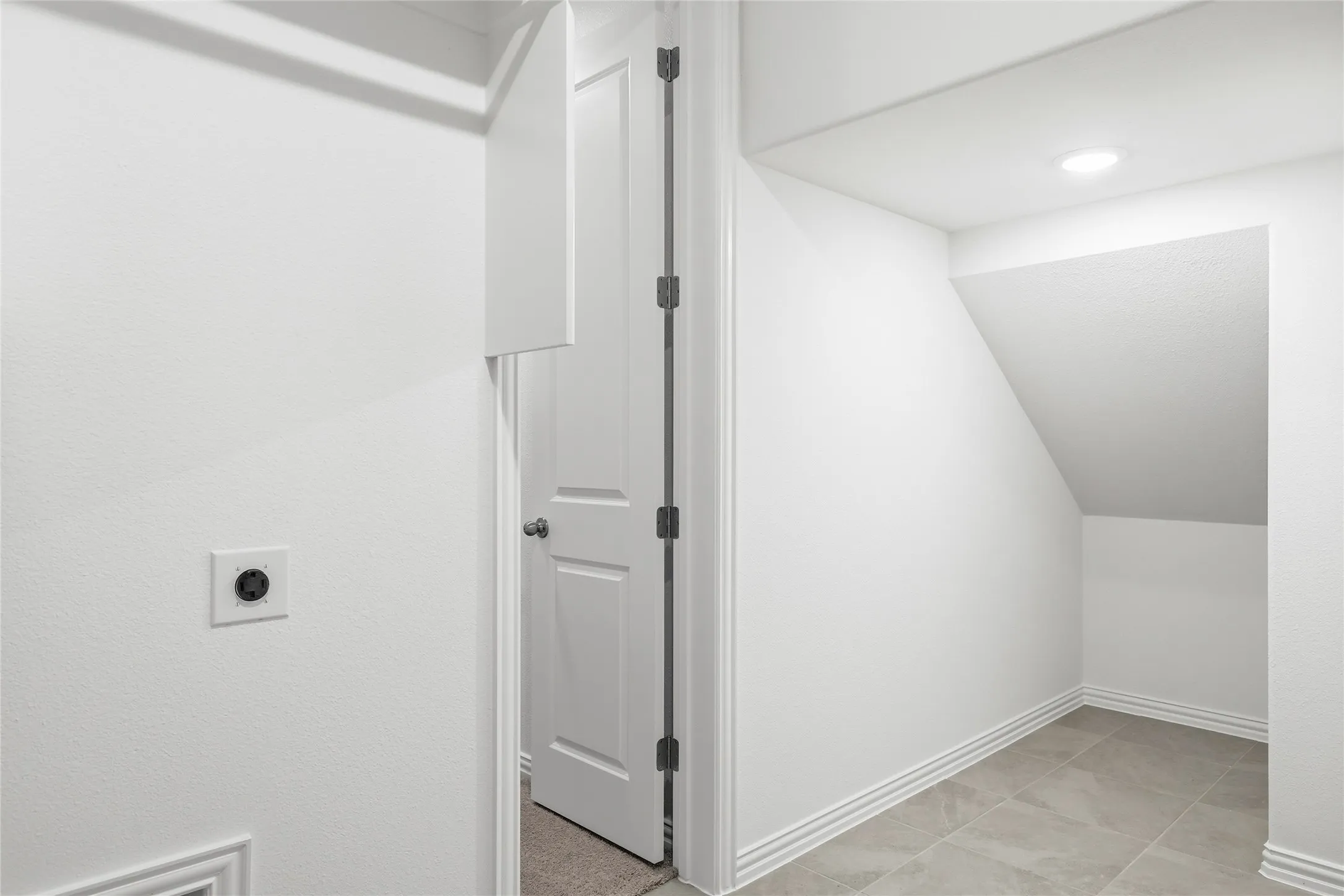 Bright room featuring dark wood-finish flooring, white walls, and recessed lighting