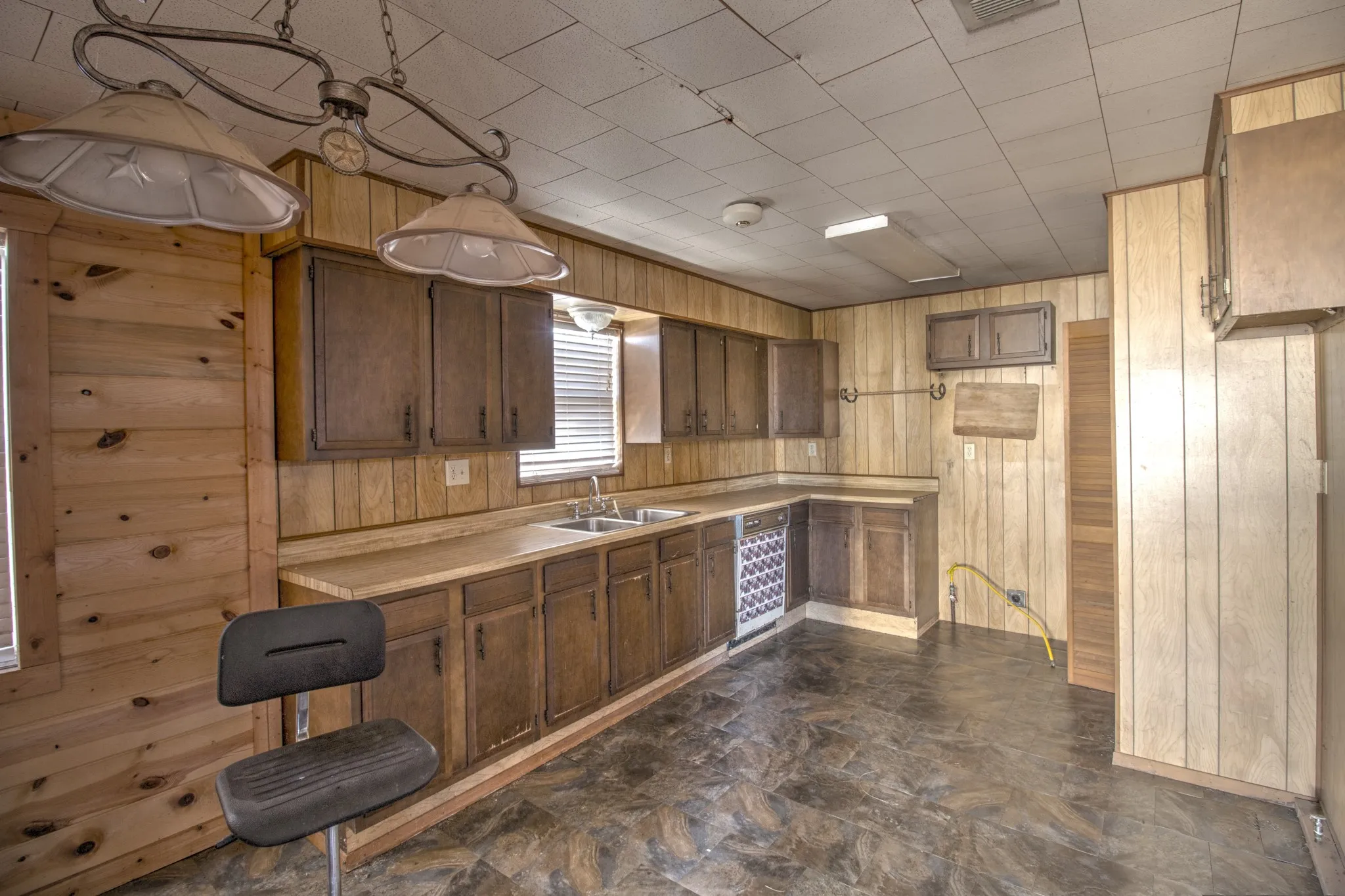 Kitchen with wood walls and light countertops