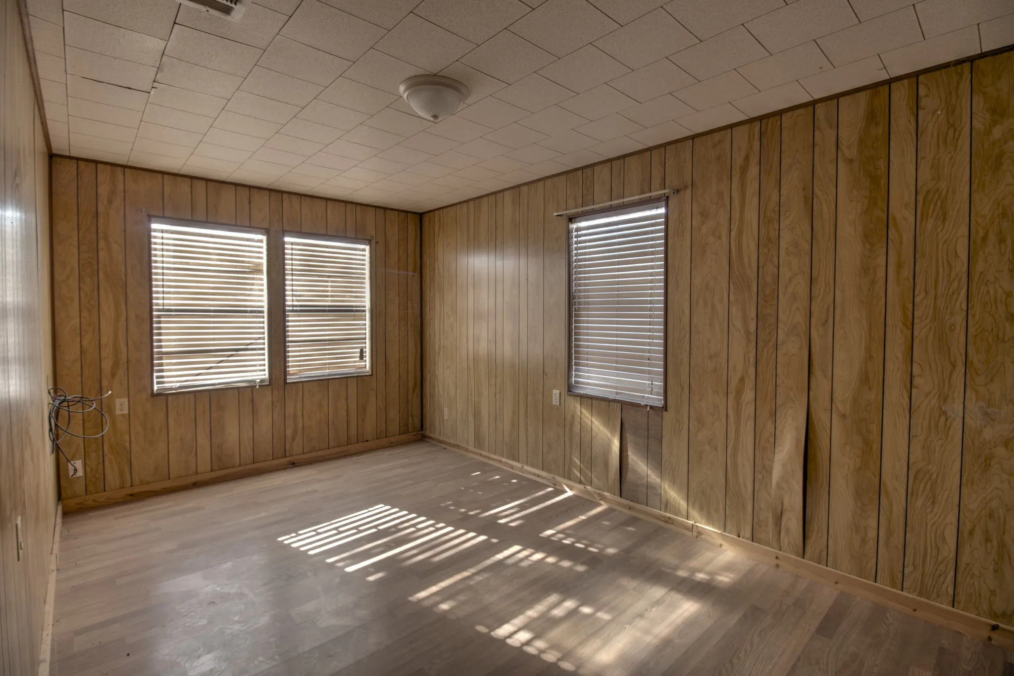 Spare room with wood walls and wood finished floors