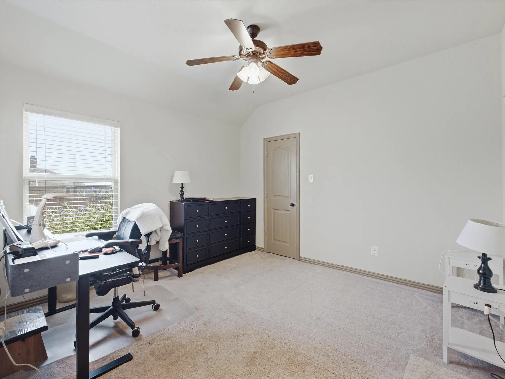 Bright room with carpeted flooring, a window with blinds, and a ceiling fan