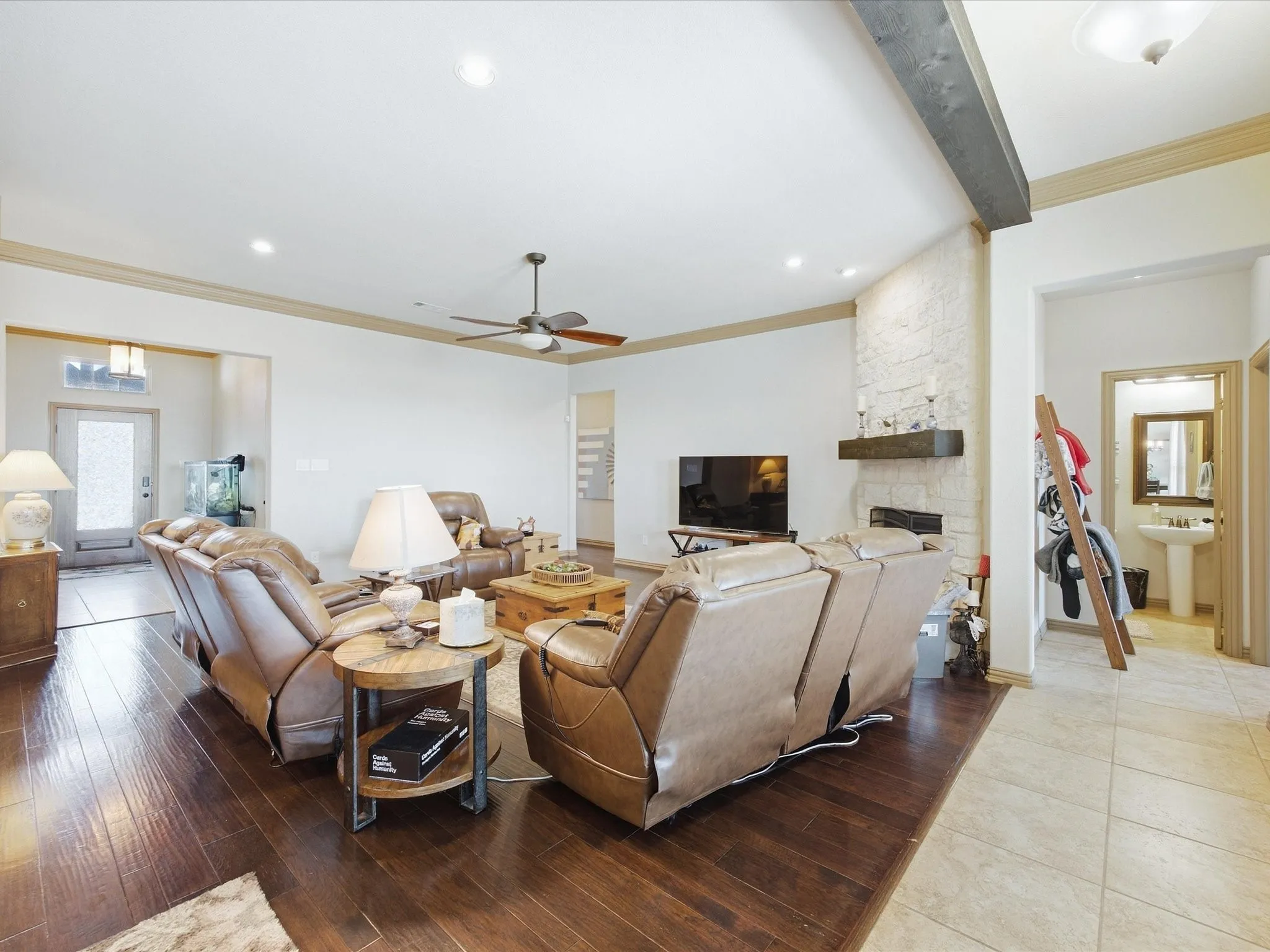 Spacious living area featuring wood-finish flooring, recessed lighting, and a ceiling fan