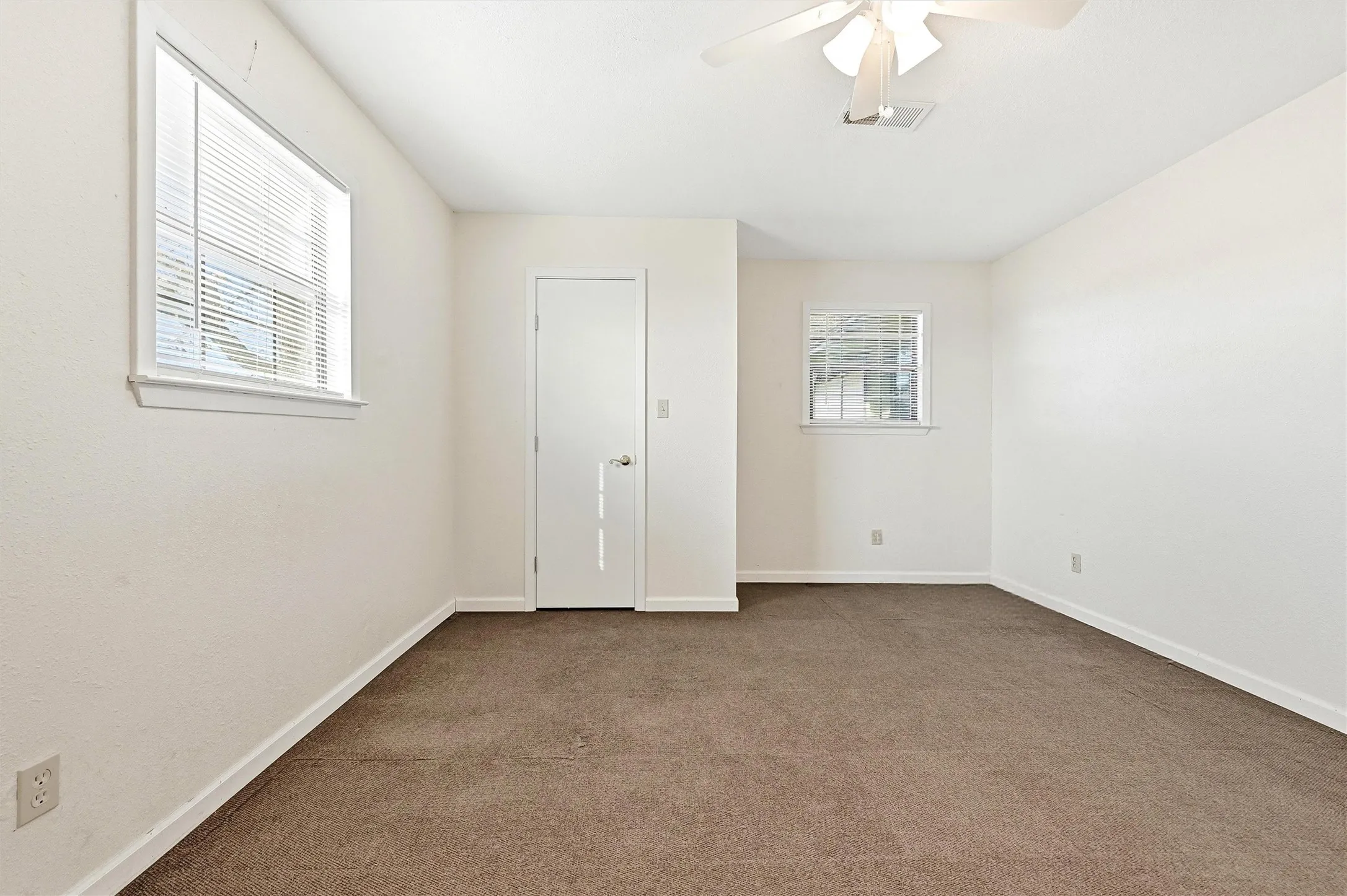 Unfurnished bedroom with carpet floors and ceiling fan