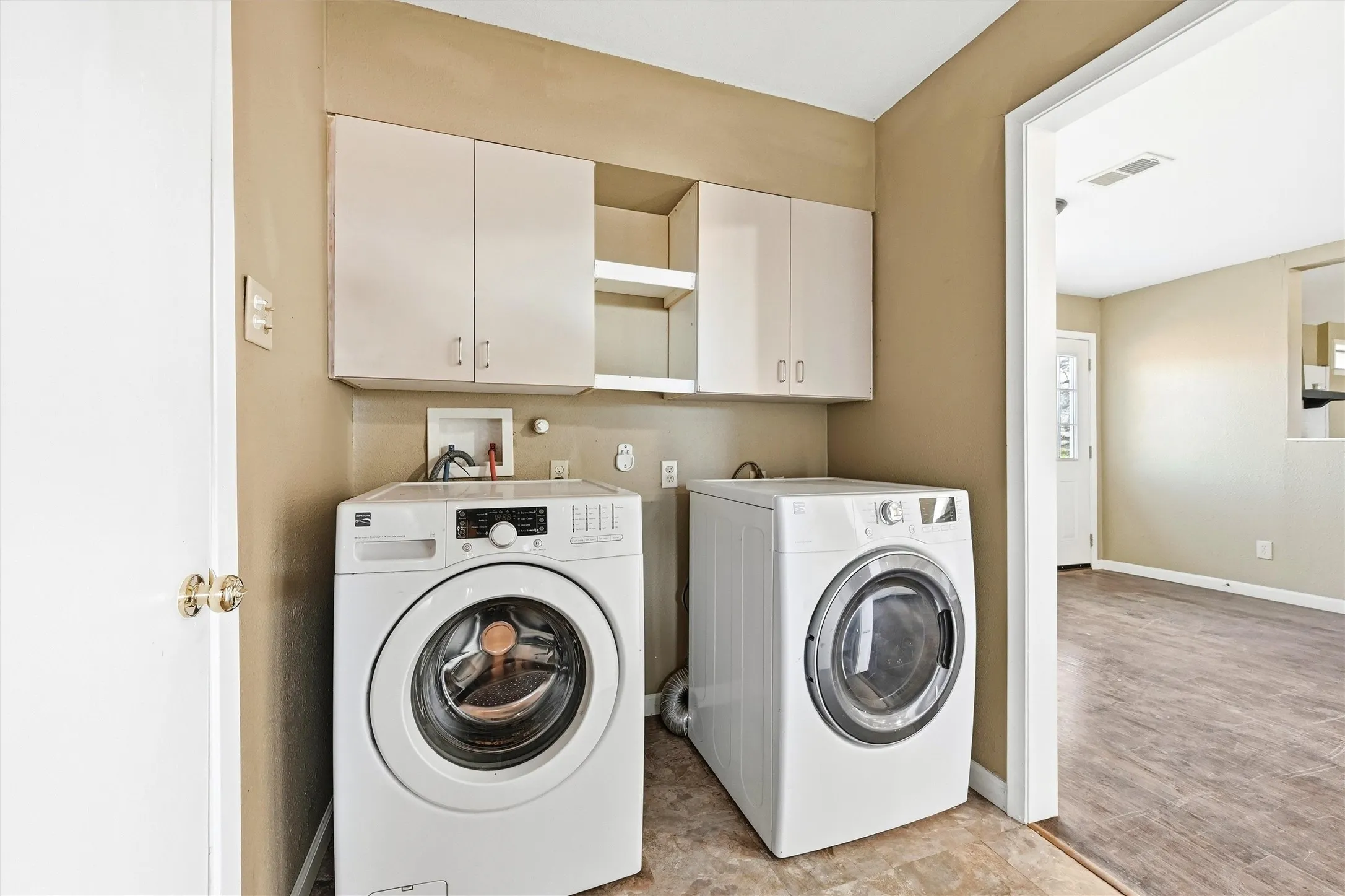 Laundry area featuring washer and dryer and cabinet space
