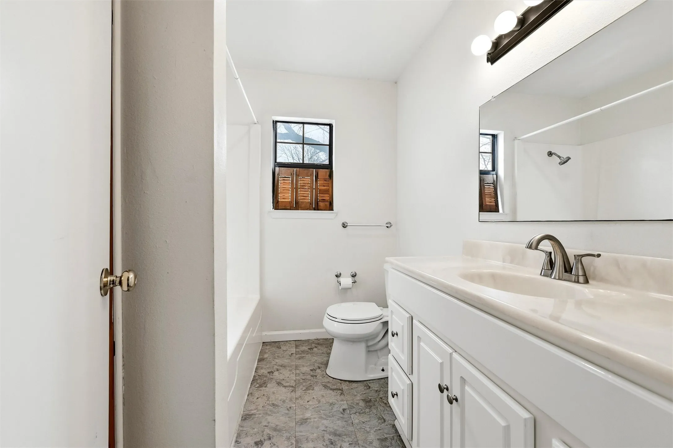 Bathroom with vanity and shower / tub combo with curtain