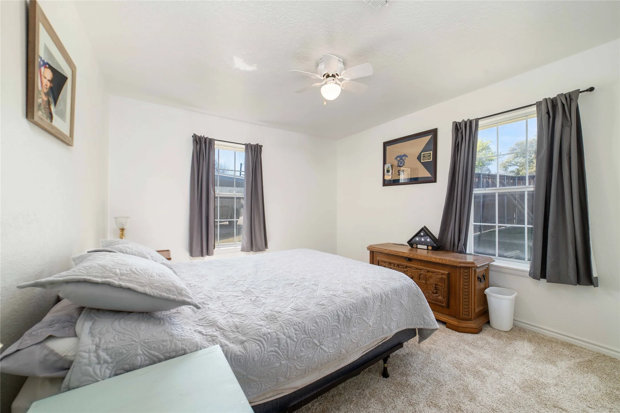 Bedroom featuring baseboards, a ceiling fan, and carpet flooring