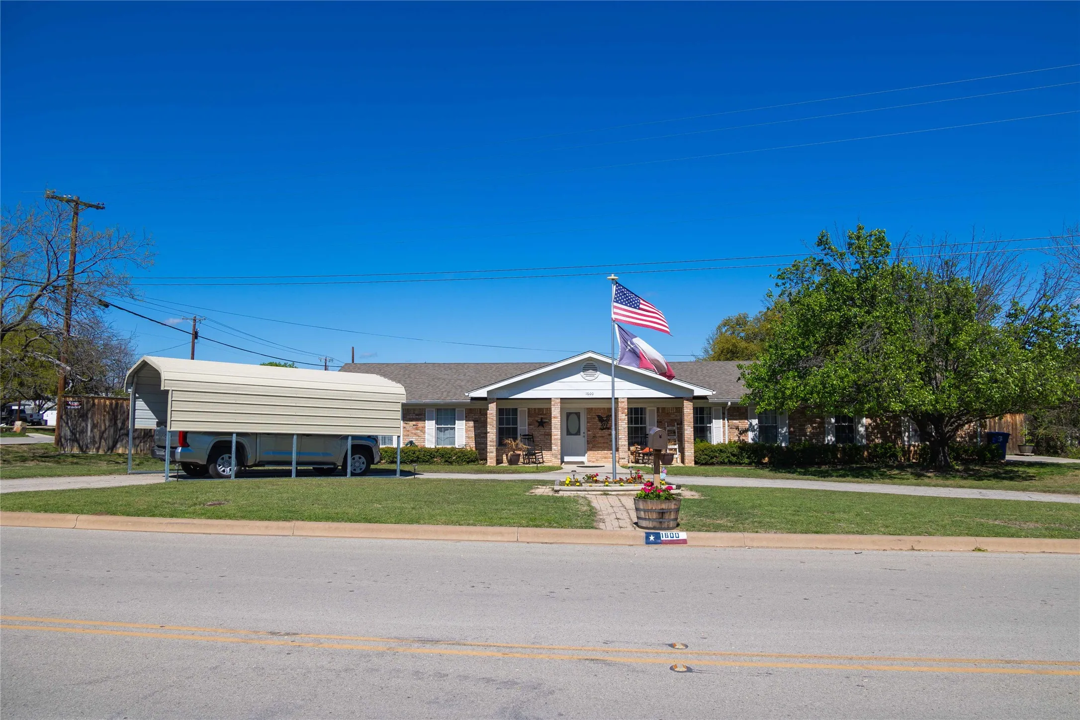 View of property featuring a detached carport