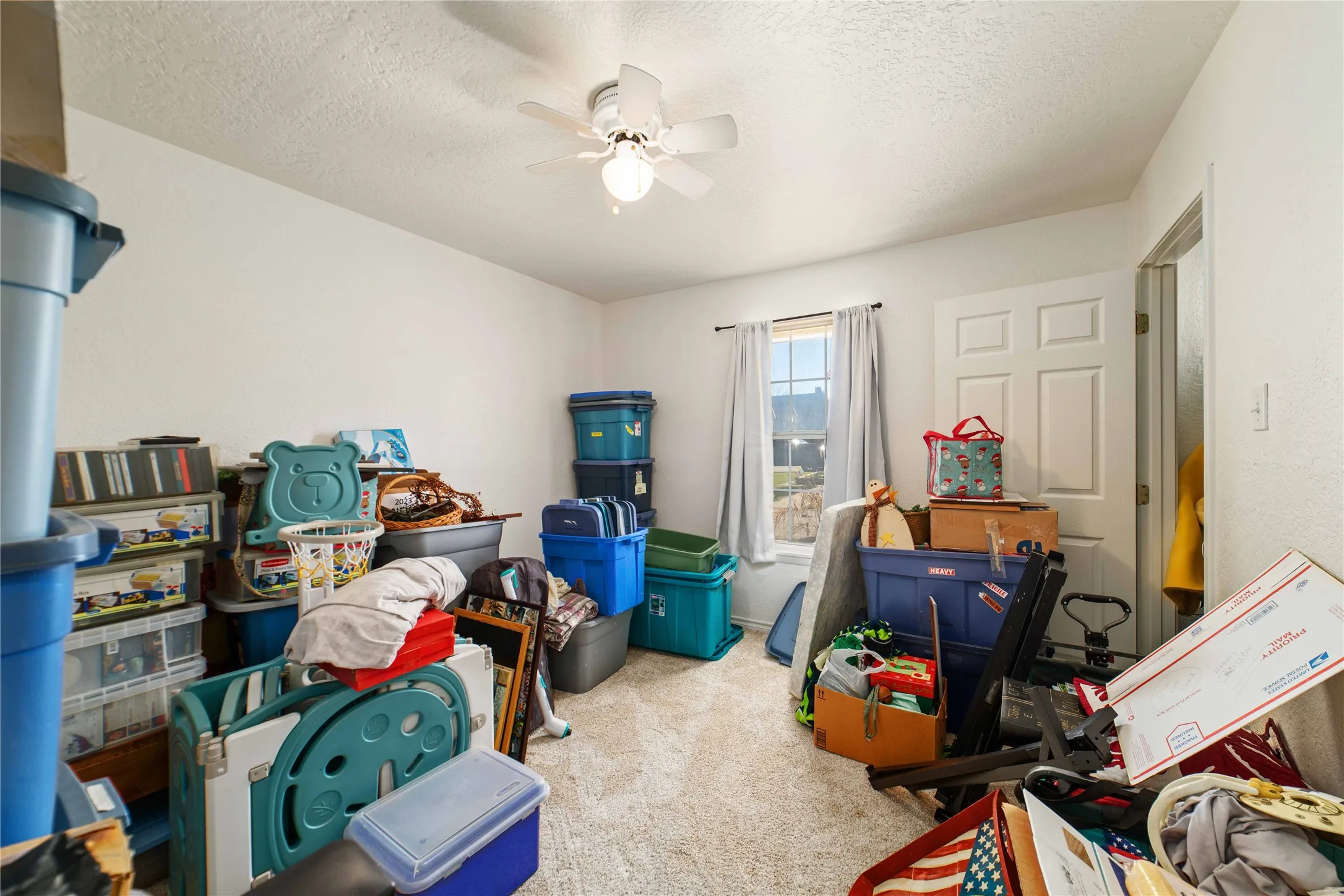 Storage area featuring a ceiling fan