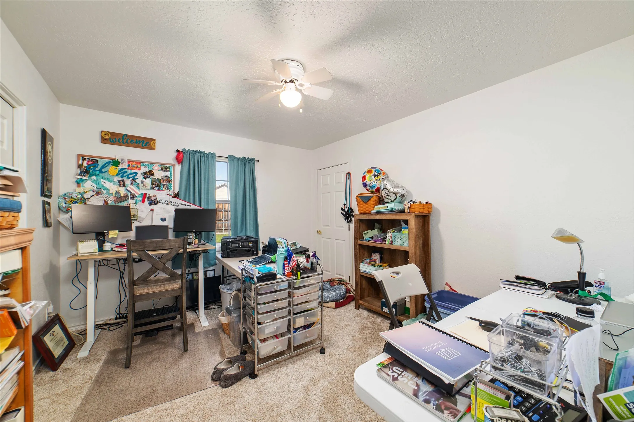 Office featuring carpet floors, a textured ceiling, and ceiling fan