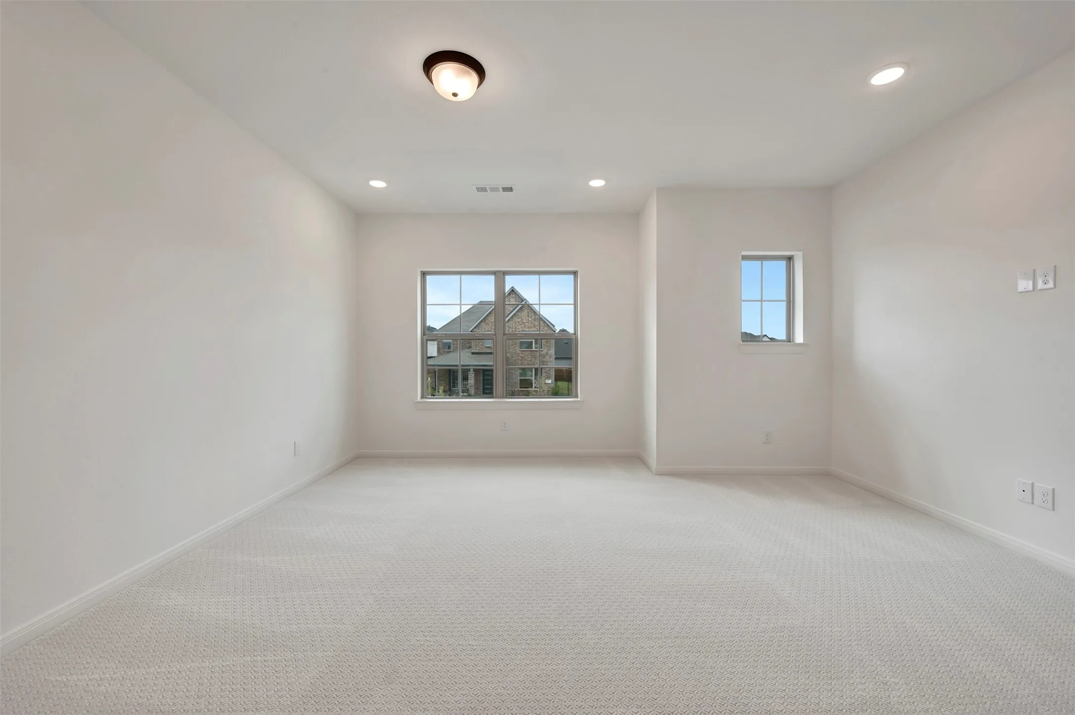 Unfurnished room with recessed lighting and light carpet