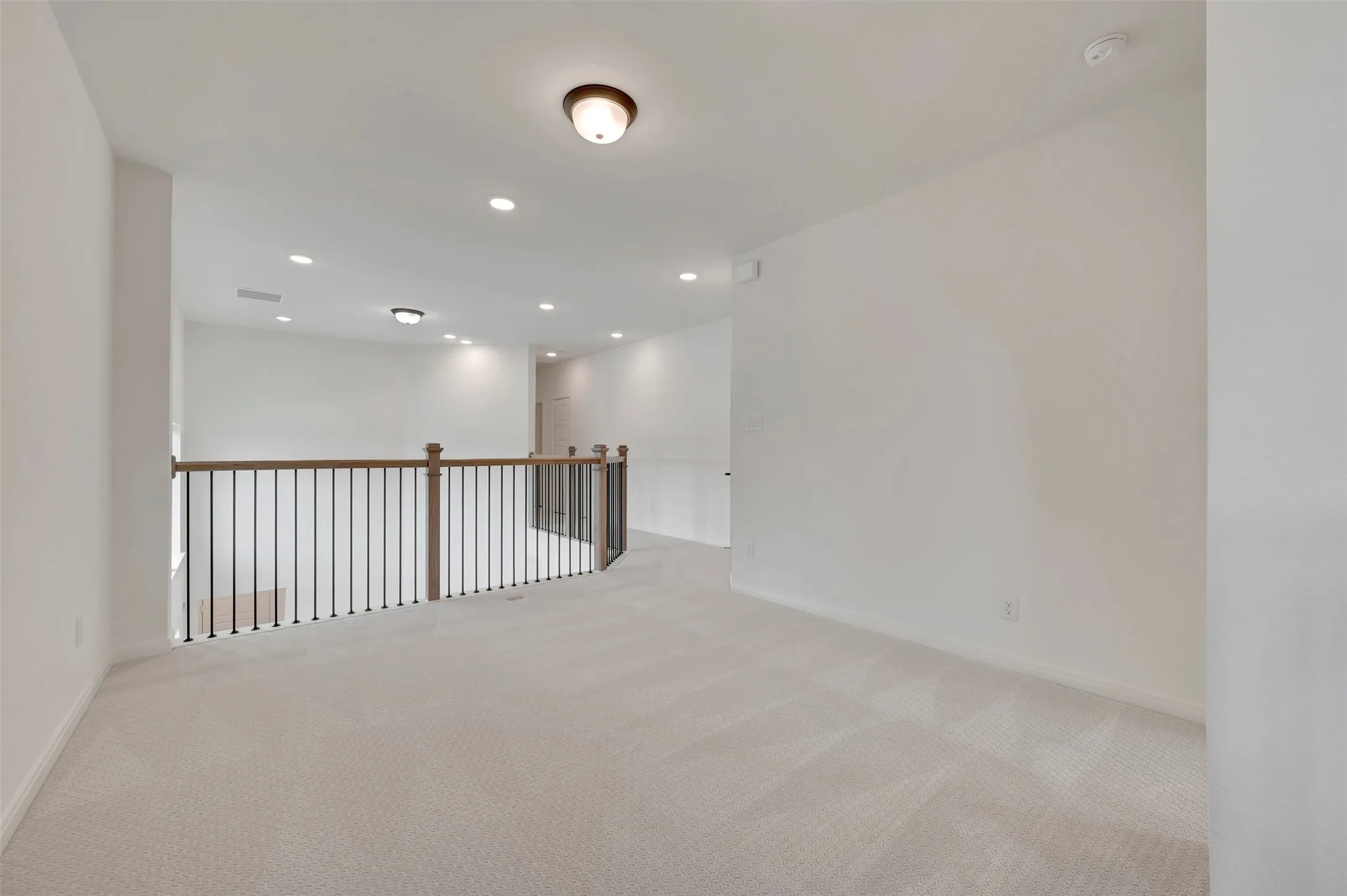 Spare room with light colored carpet and recessed lighting