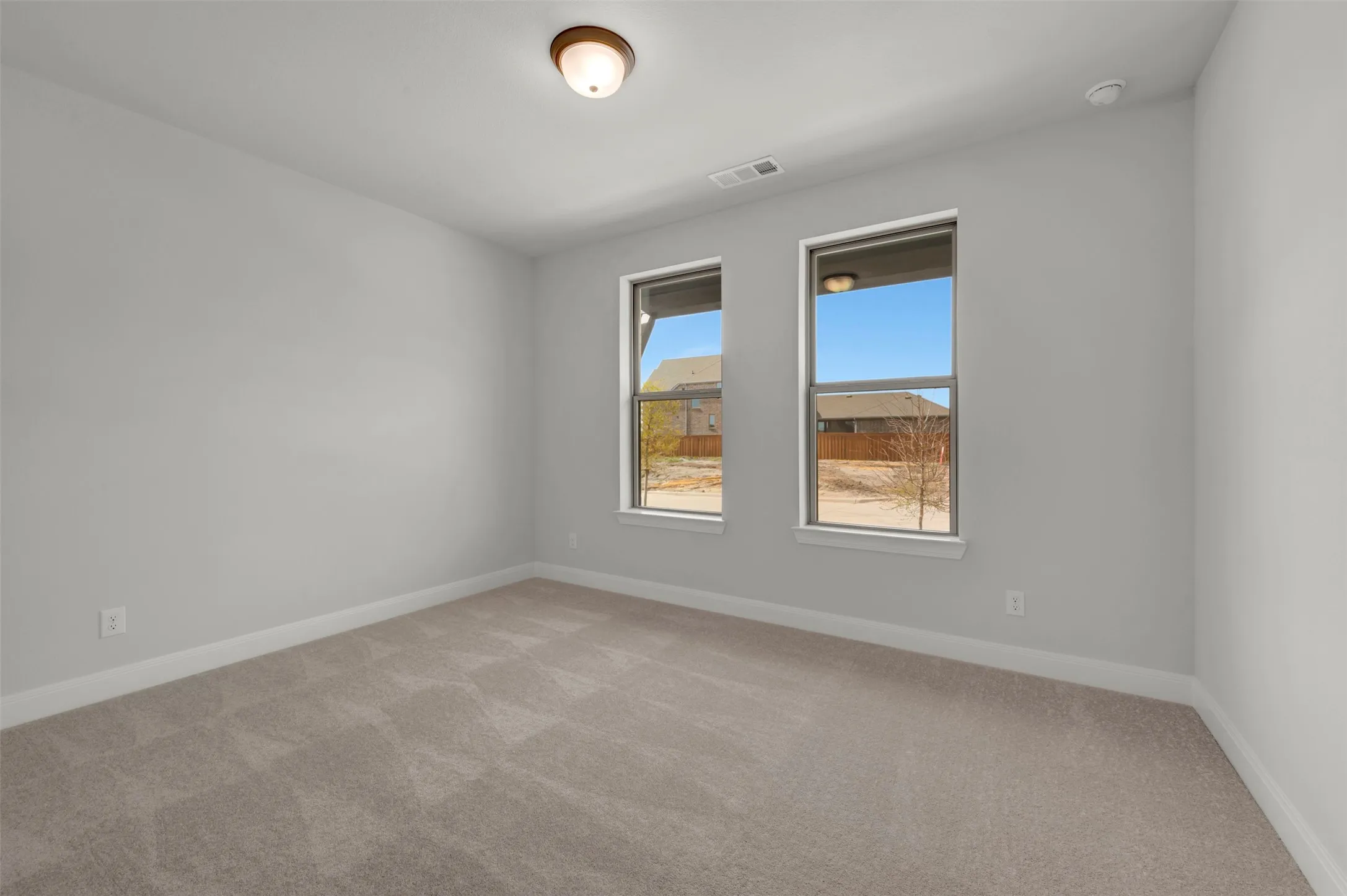 Carpeted empty room with baseboards